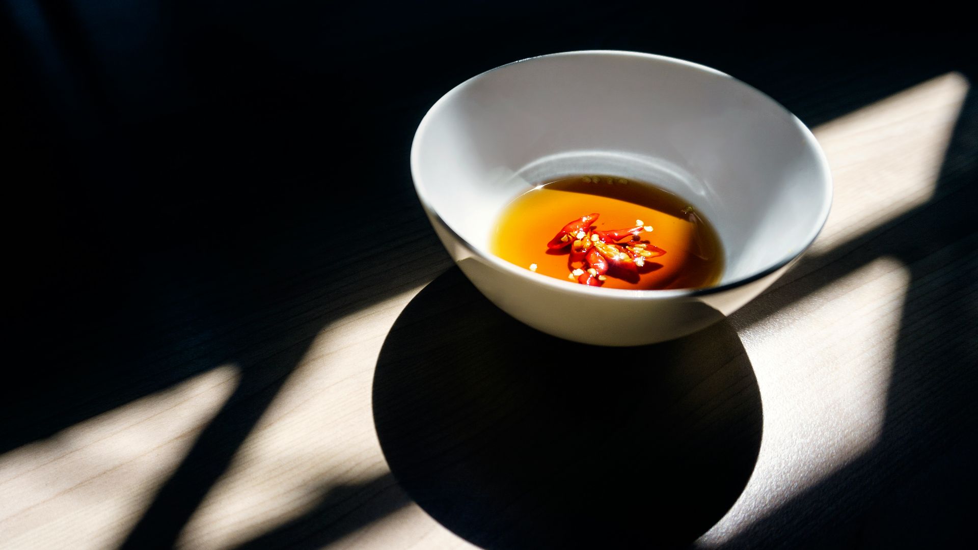 white ceramic bowl on wooden surface