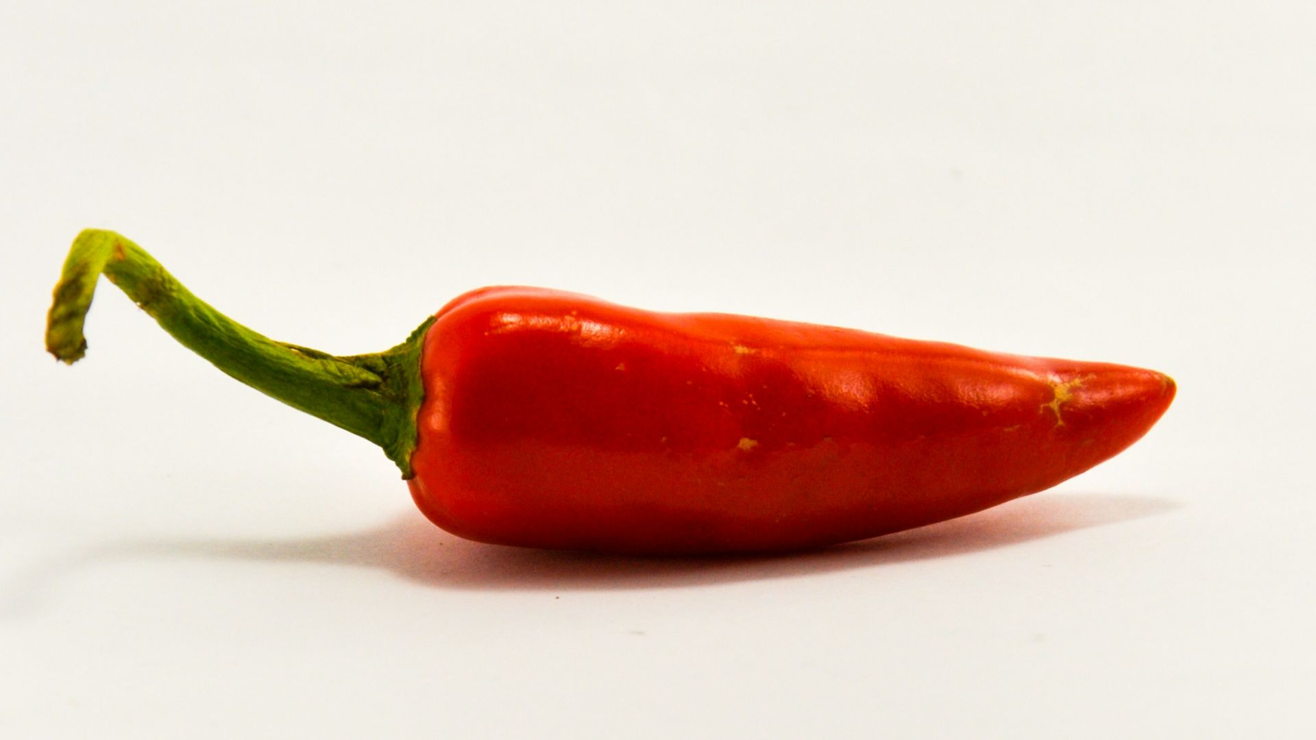 red chili on white surface