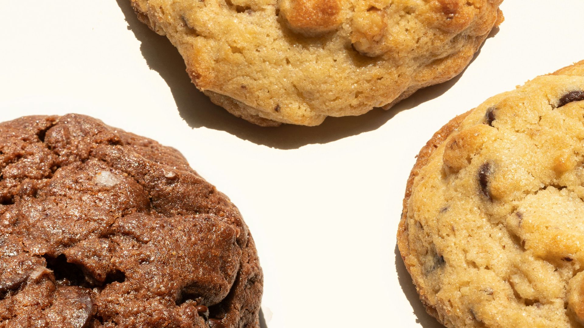 a close up of four chocolate chip cookies