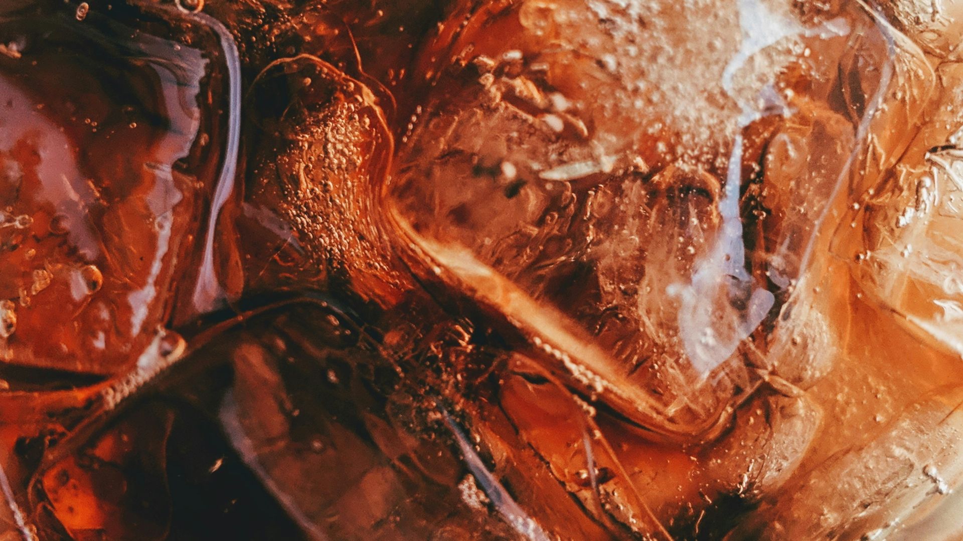 drinking glass filled with soda and ice