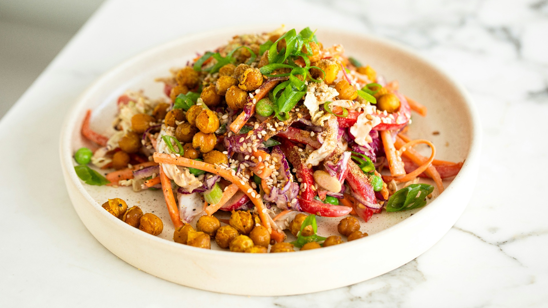 a white bowl filled with a salad on top of a table