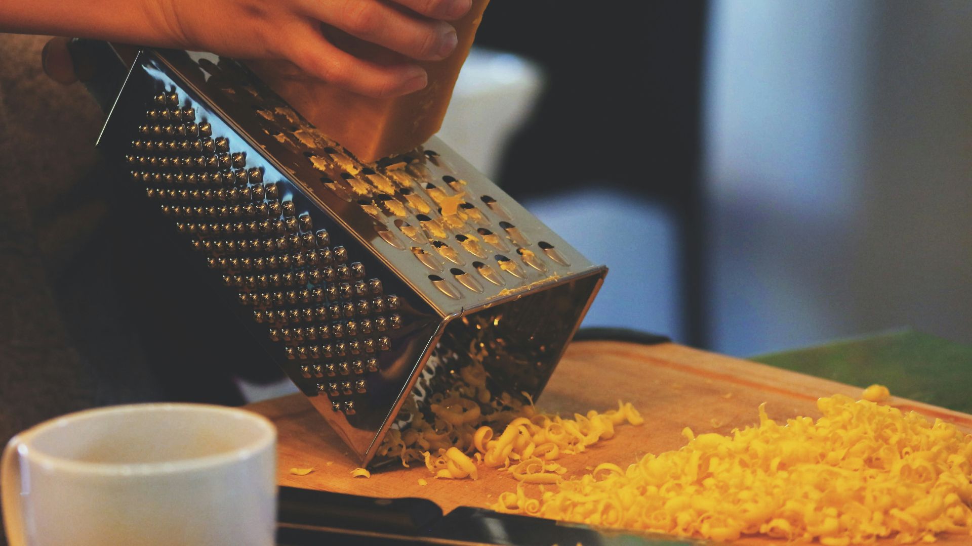 person grating cheese