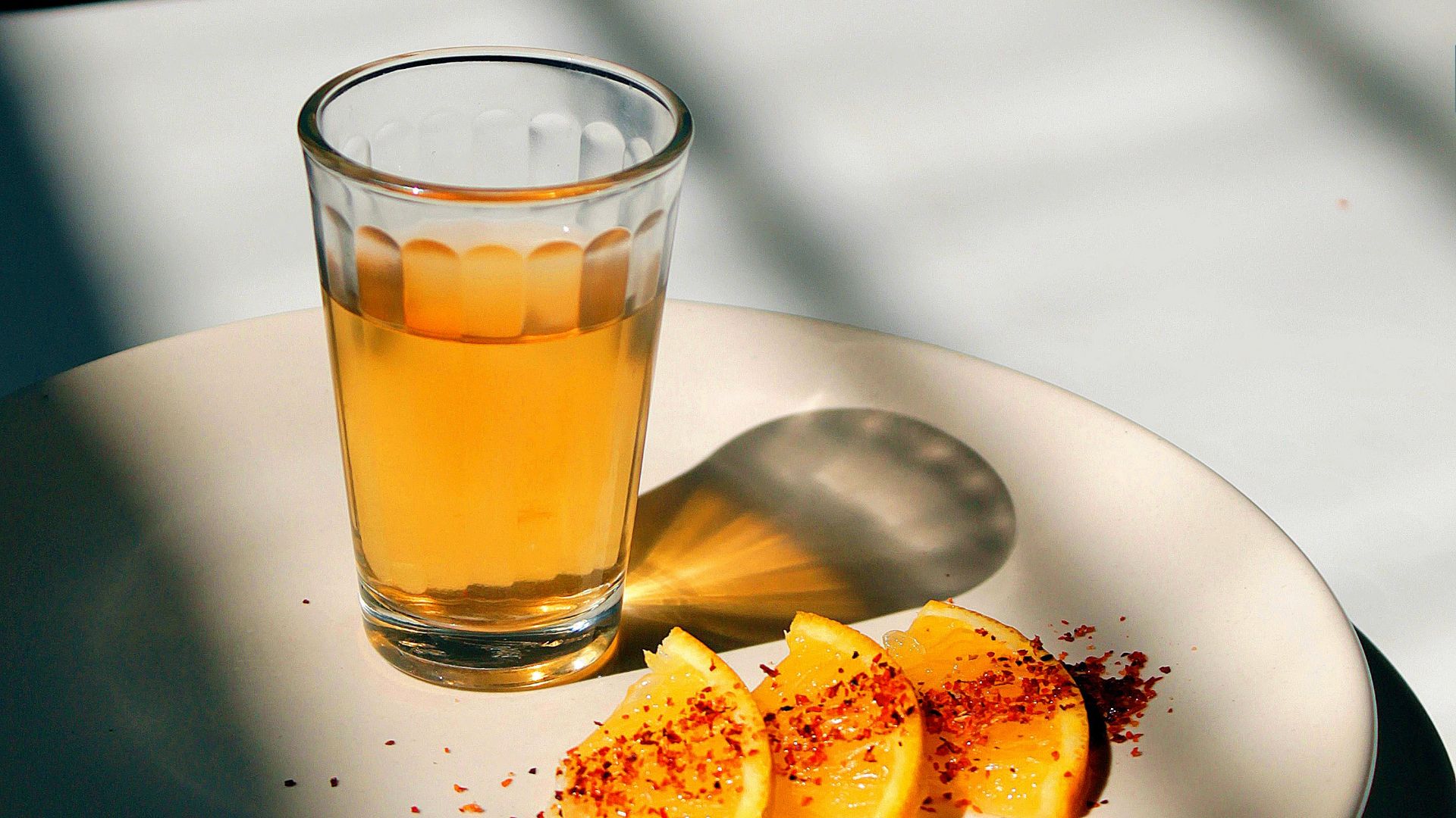round white ceramic plate with sliced oranges