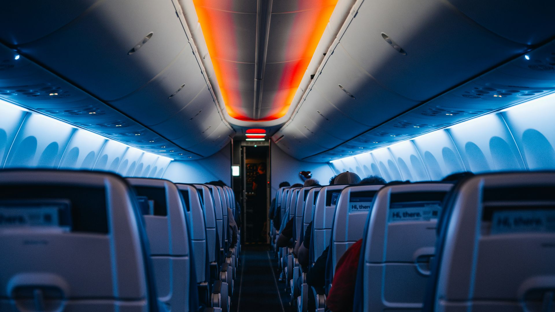 The inside of an airplane with the lights on