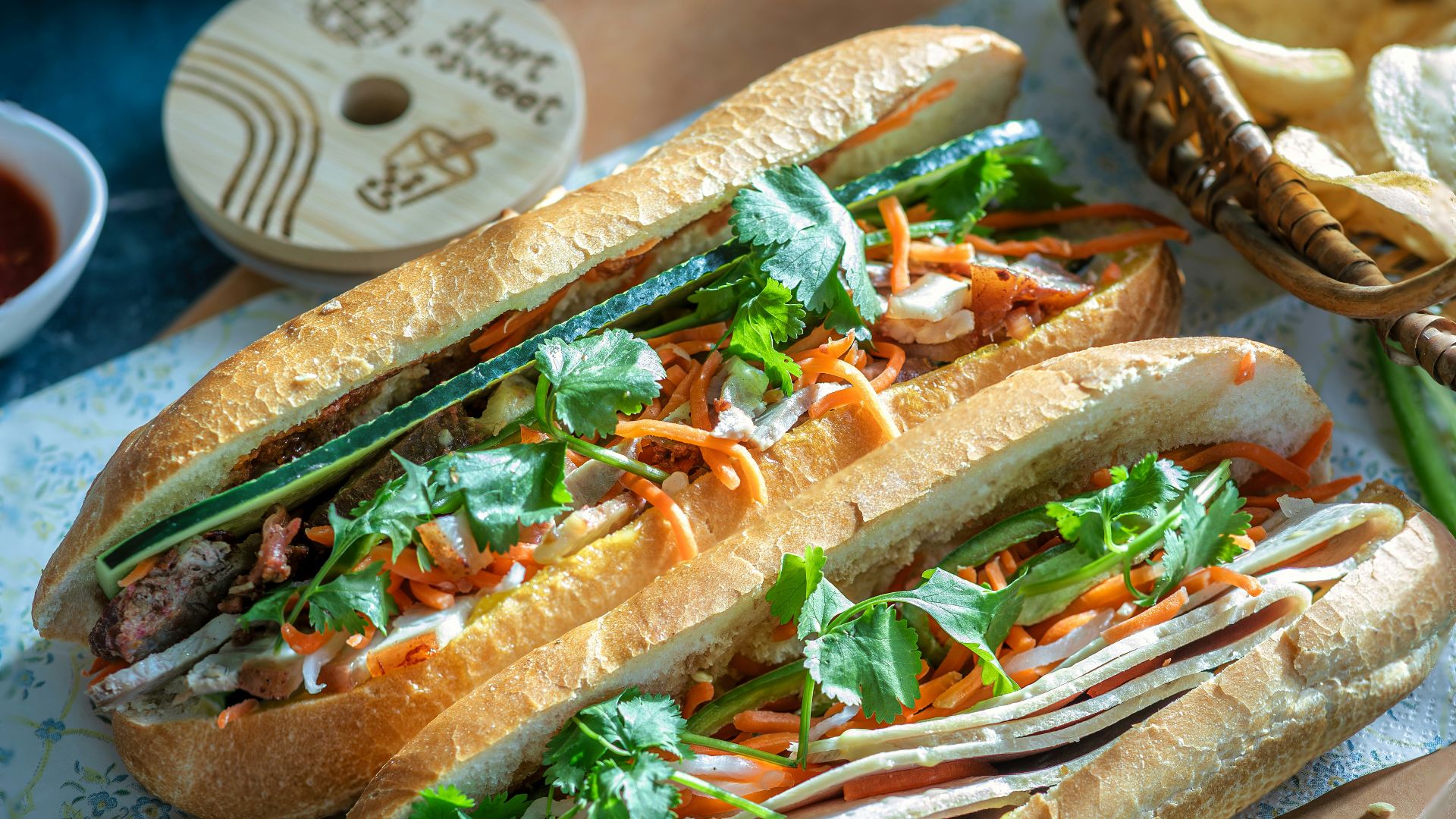 a couple of sandwiches sitting on top of a cutting board