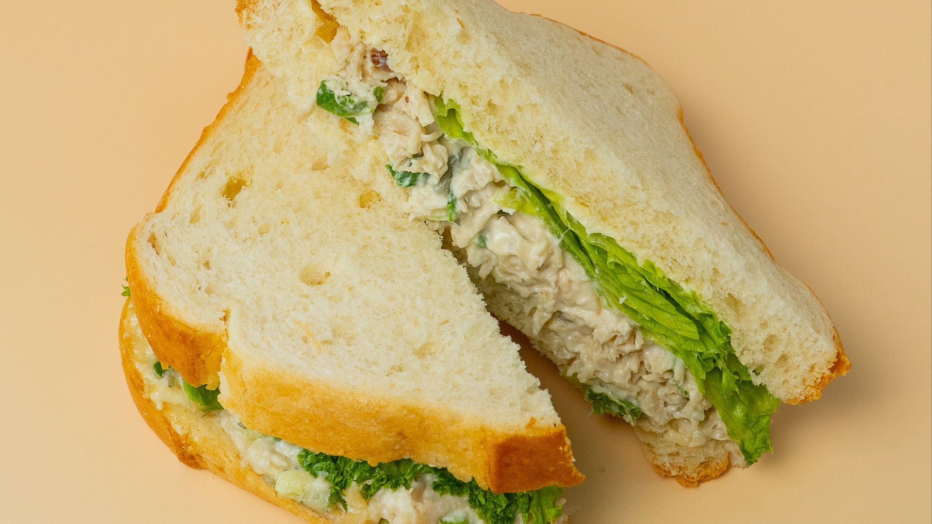 Chicken salad sandwich with lettuce on white bread
