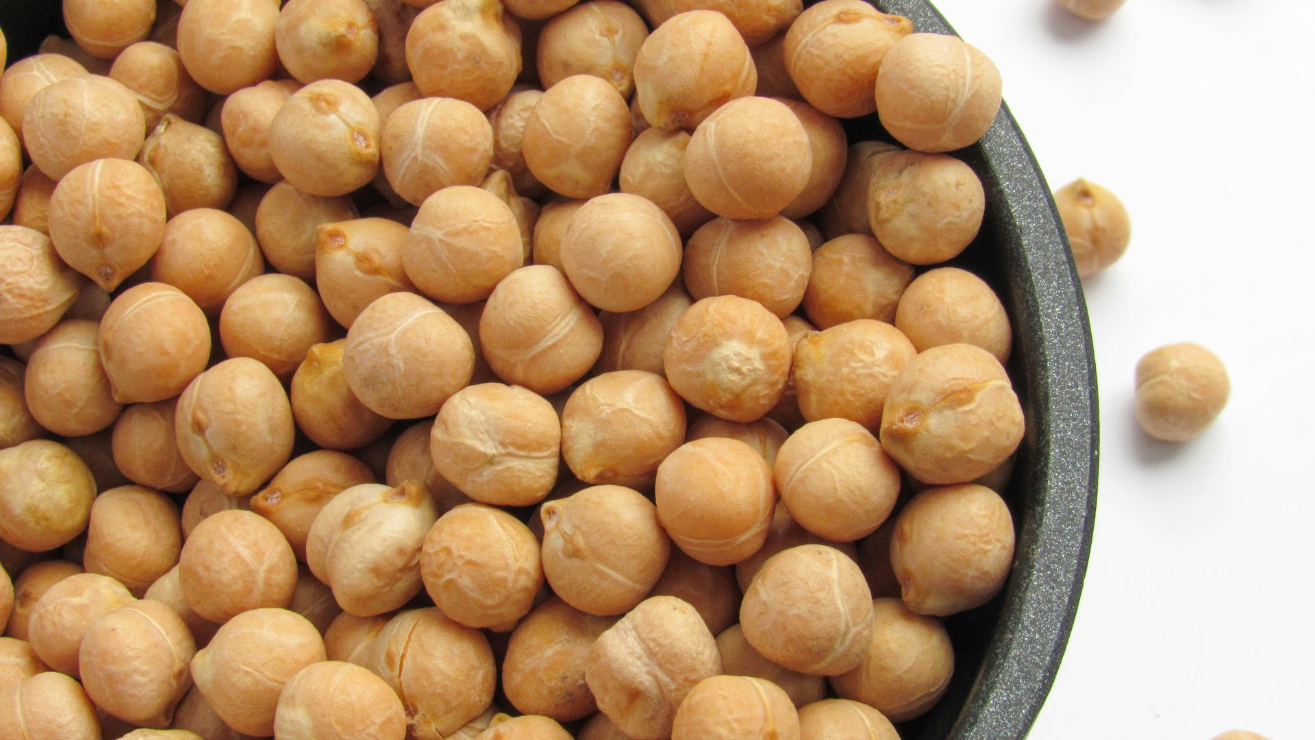 a bowl filled with chickpeas sitting on top of a table