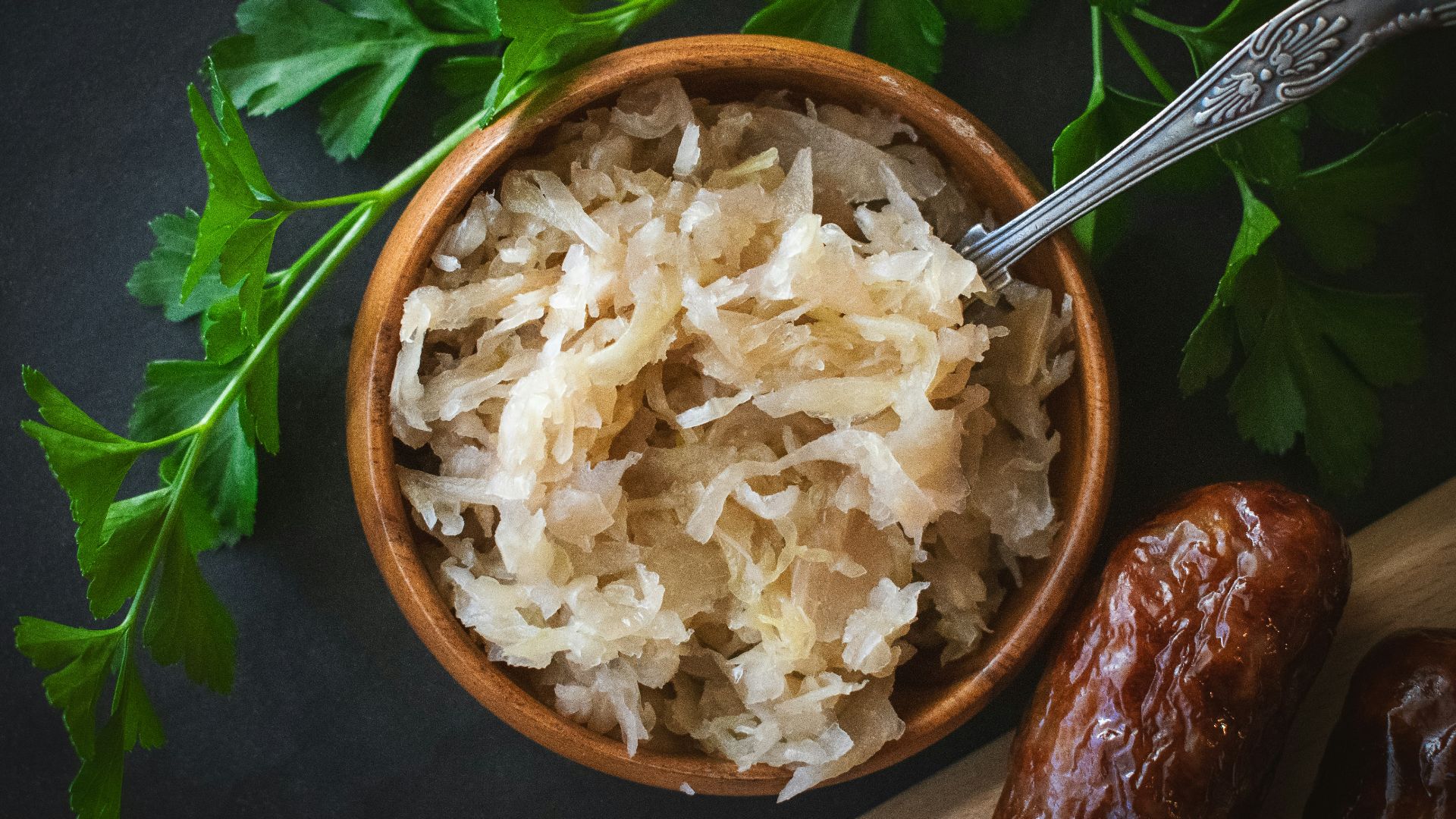a wooden bowl filled with rice next to a spoon
