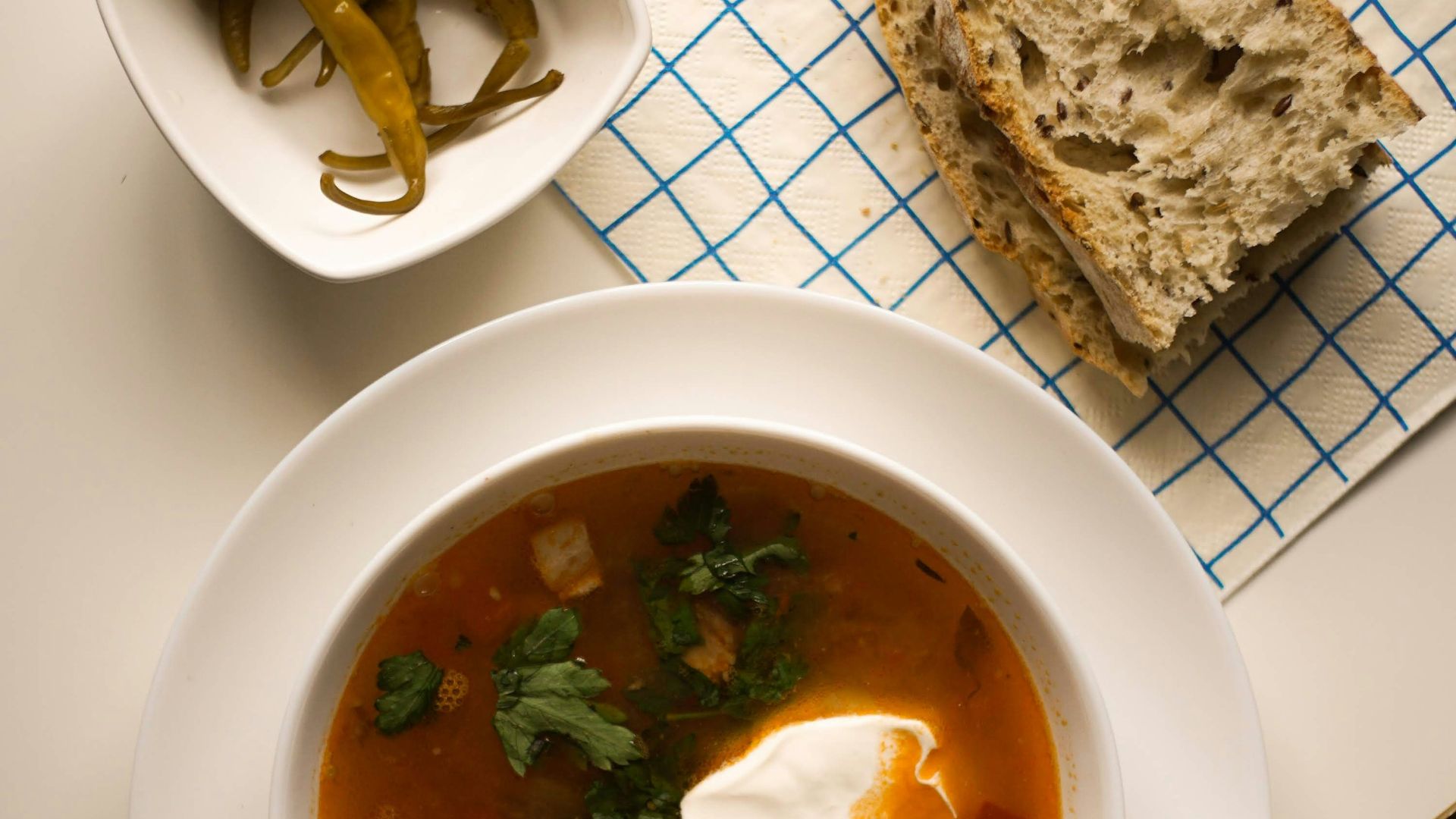 a bowl of soup and a spoon on a table