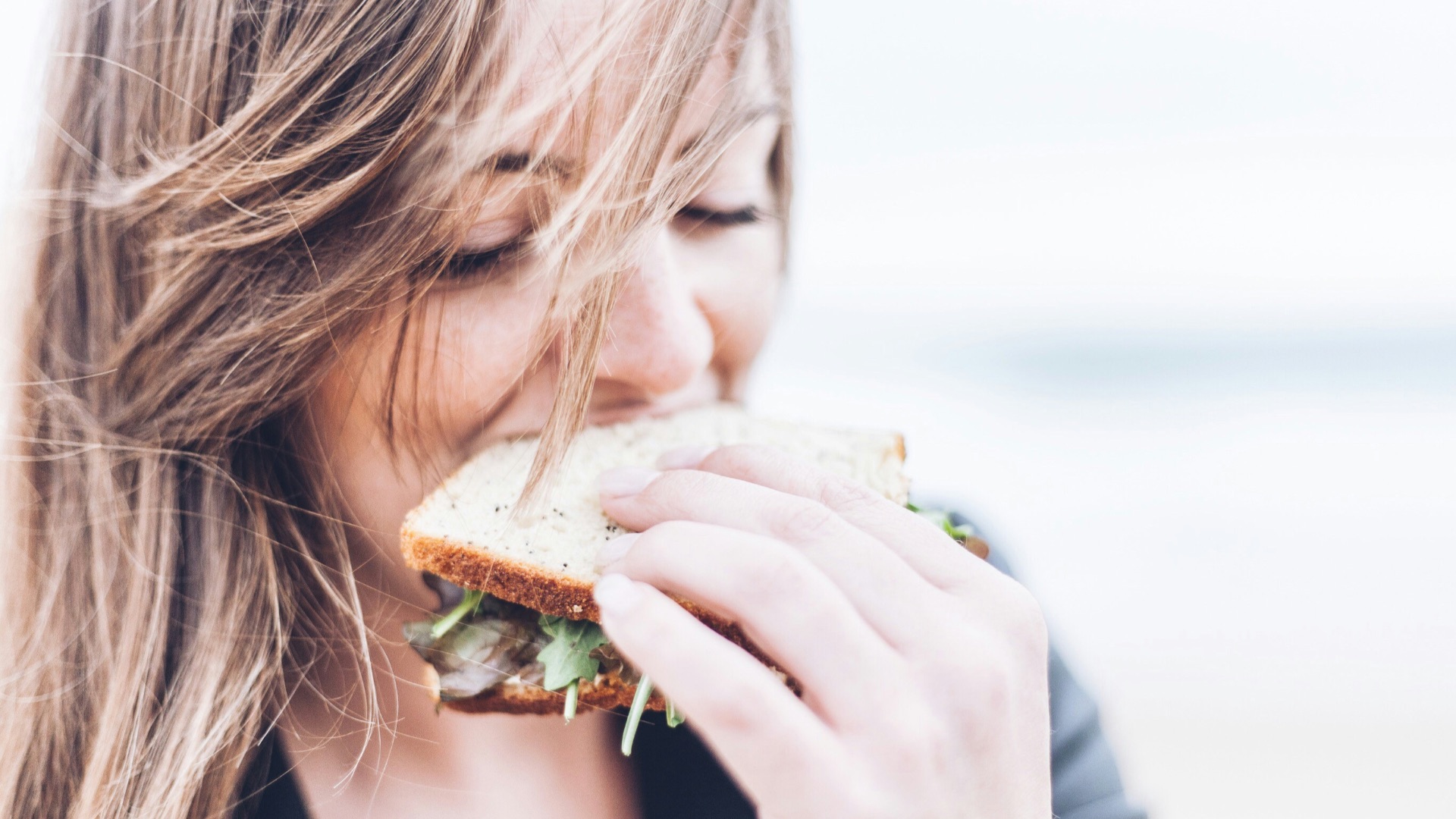 woman eating sandwich