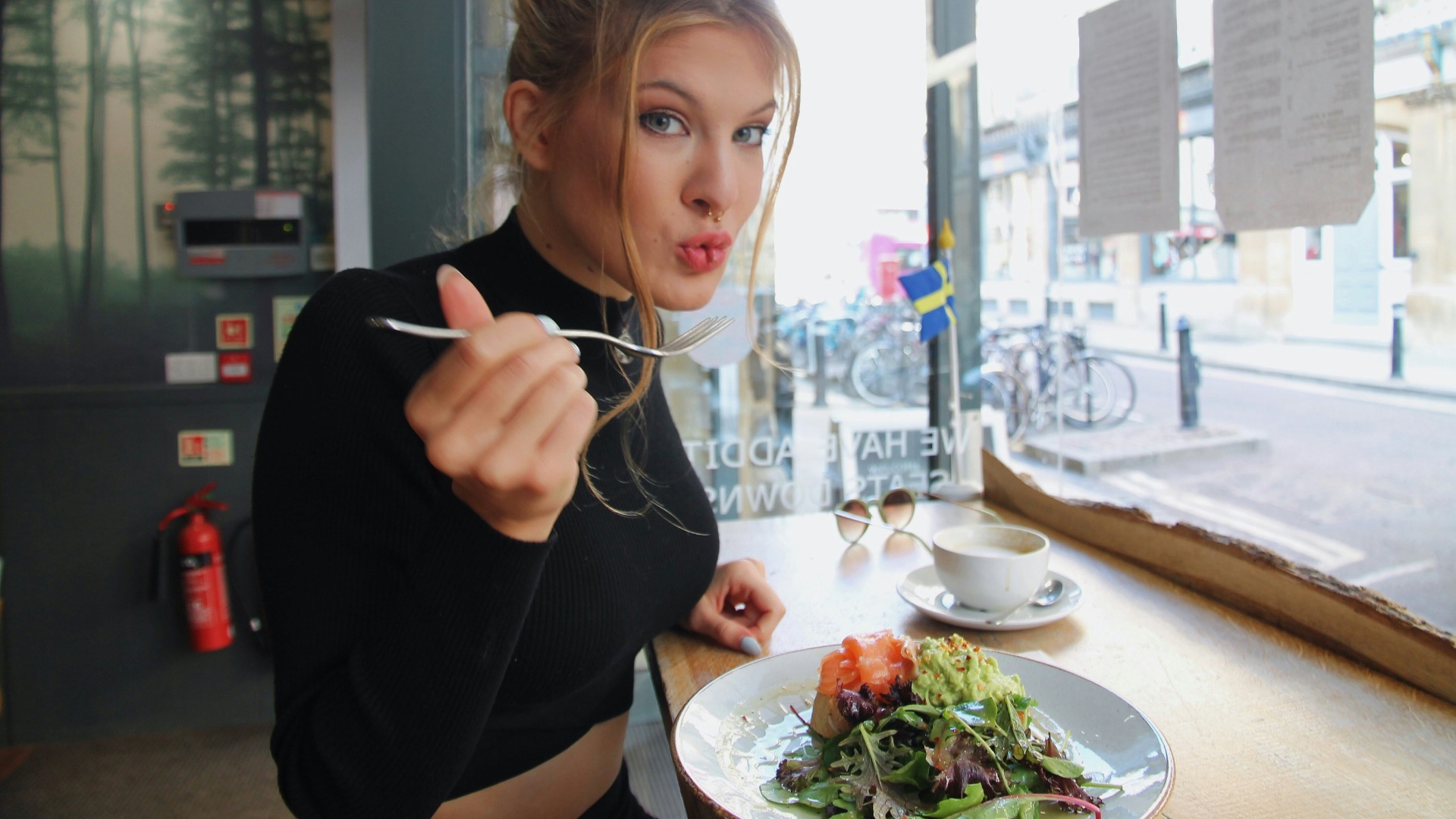 woman in black long sleeve shirt eating