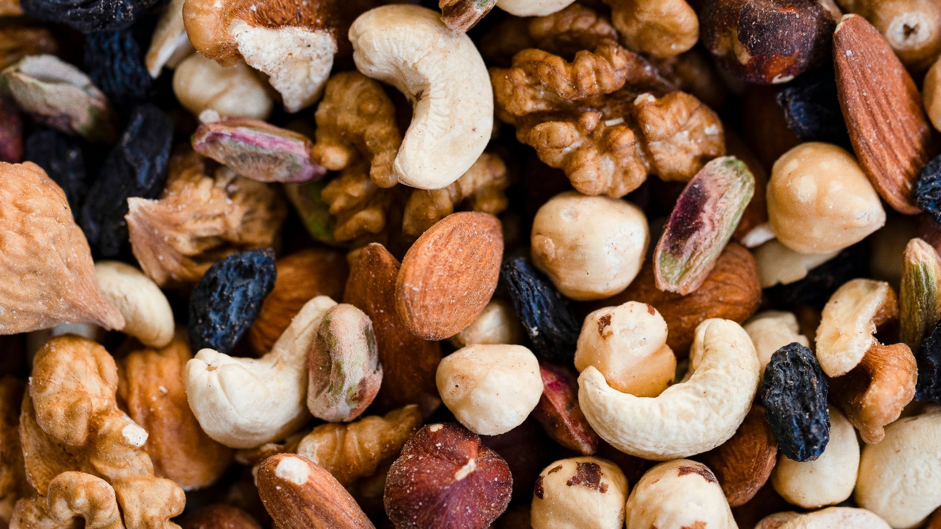 A close-up view of a mixed nut and raisin blend.