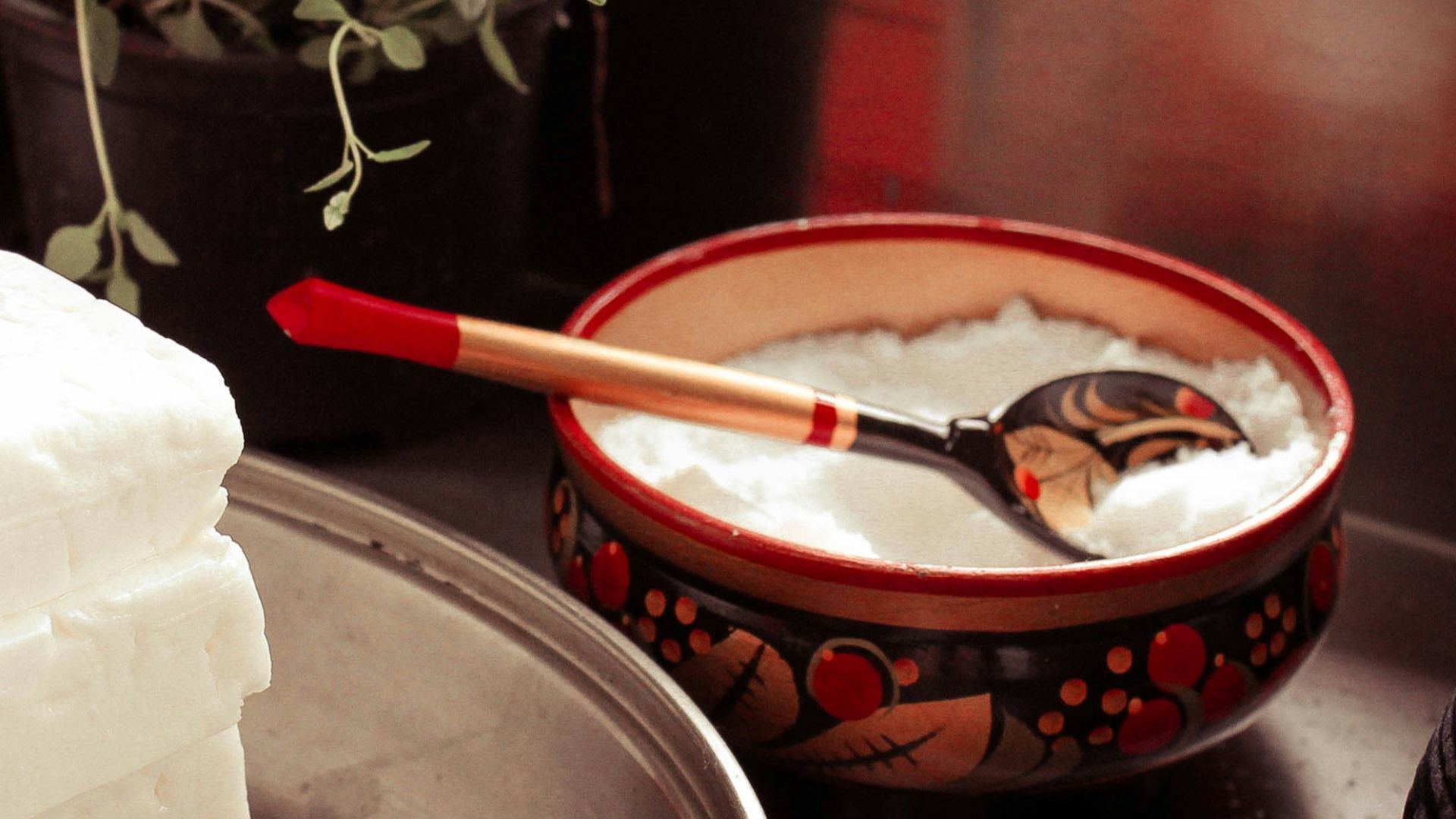 red ceramic bowl on gray spoon
