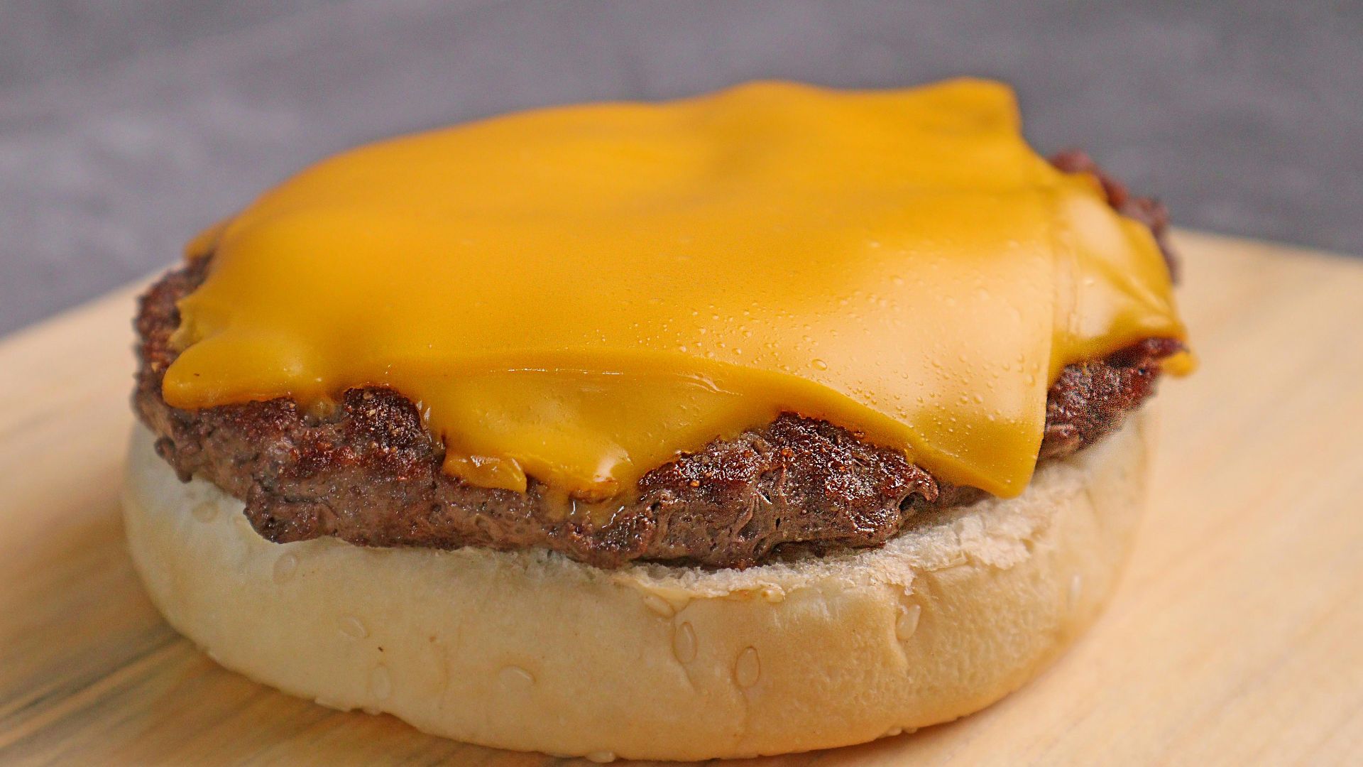 burger with cheese on brown wooden table