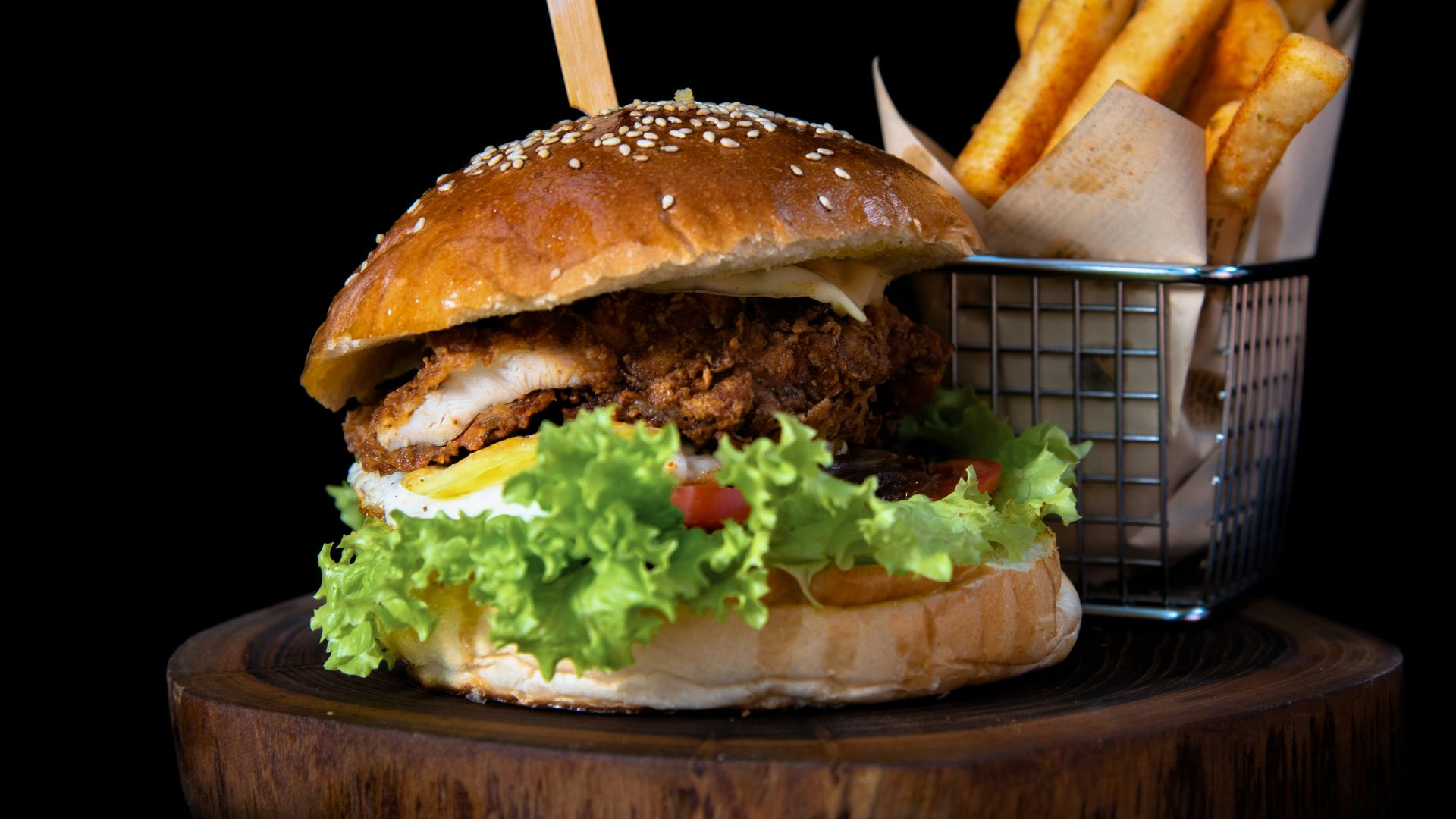 hamburger by french fries on board