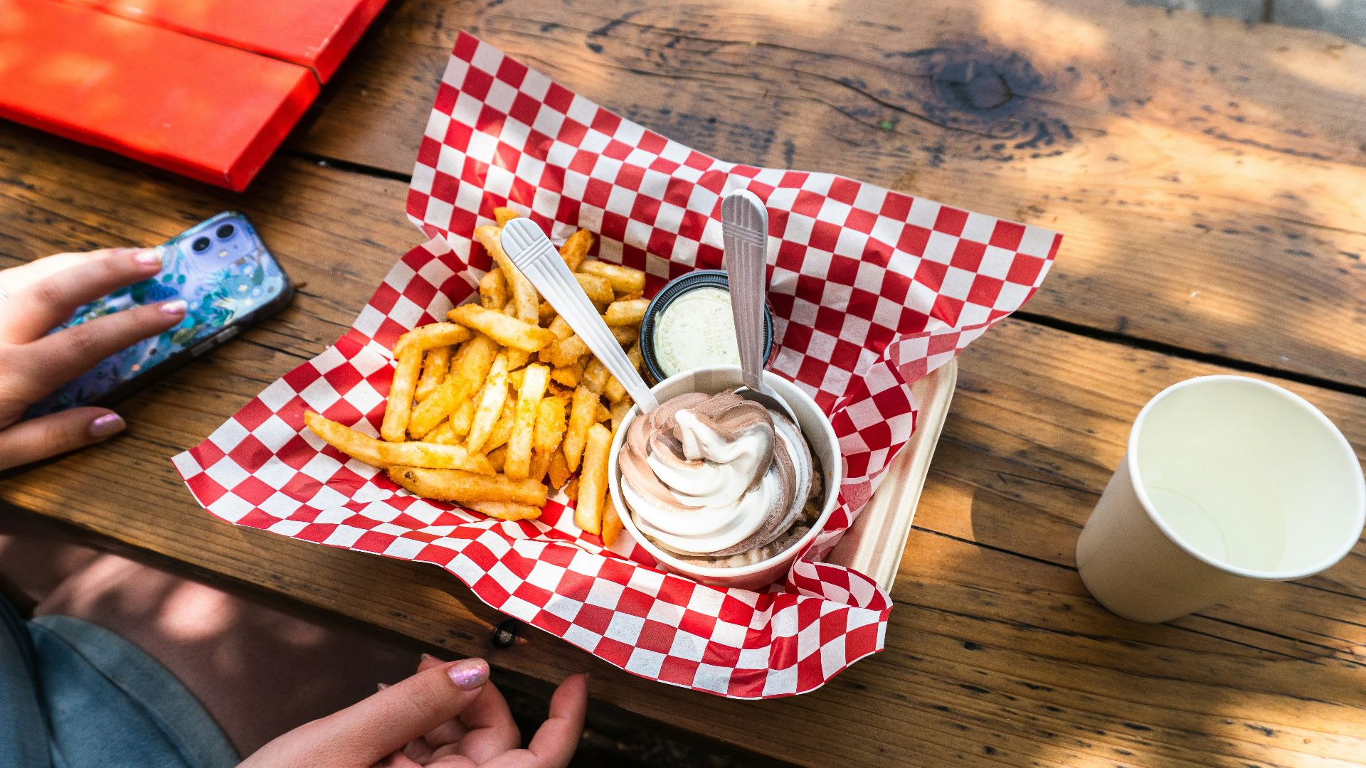 French fries and ice cream served on a checkered paper