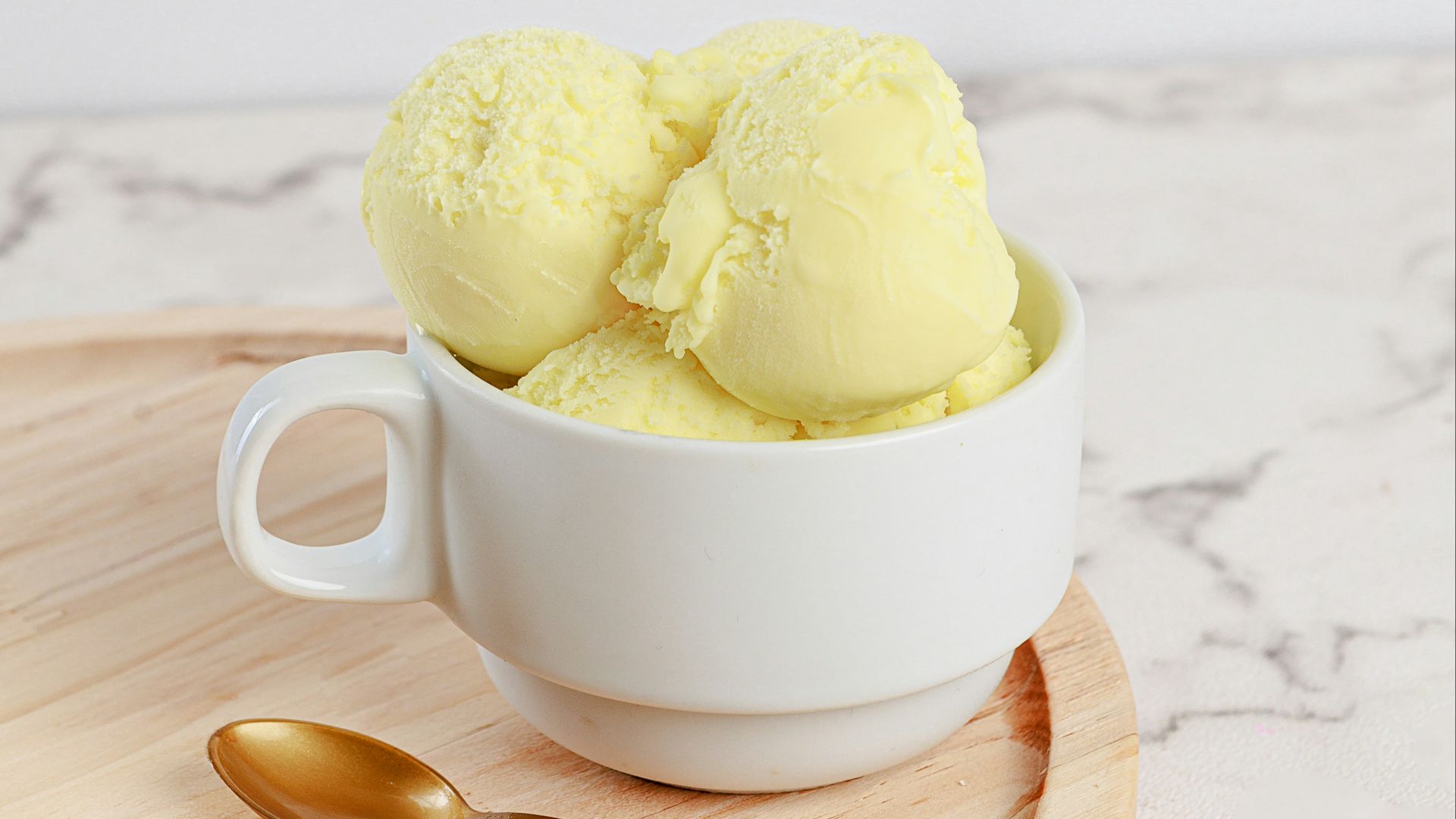 Two scoops of ice cream in a white bowl
