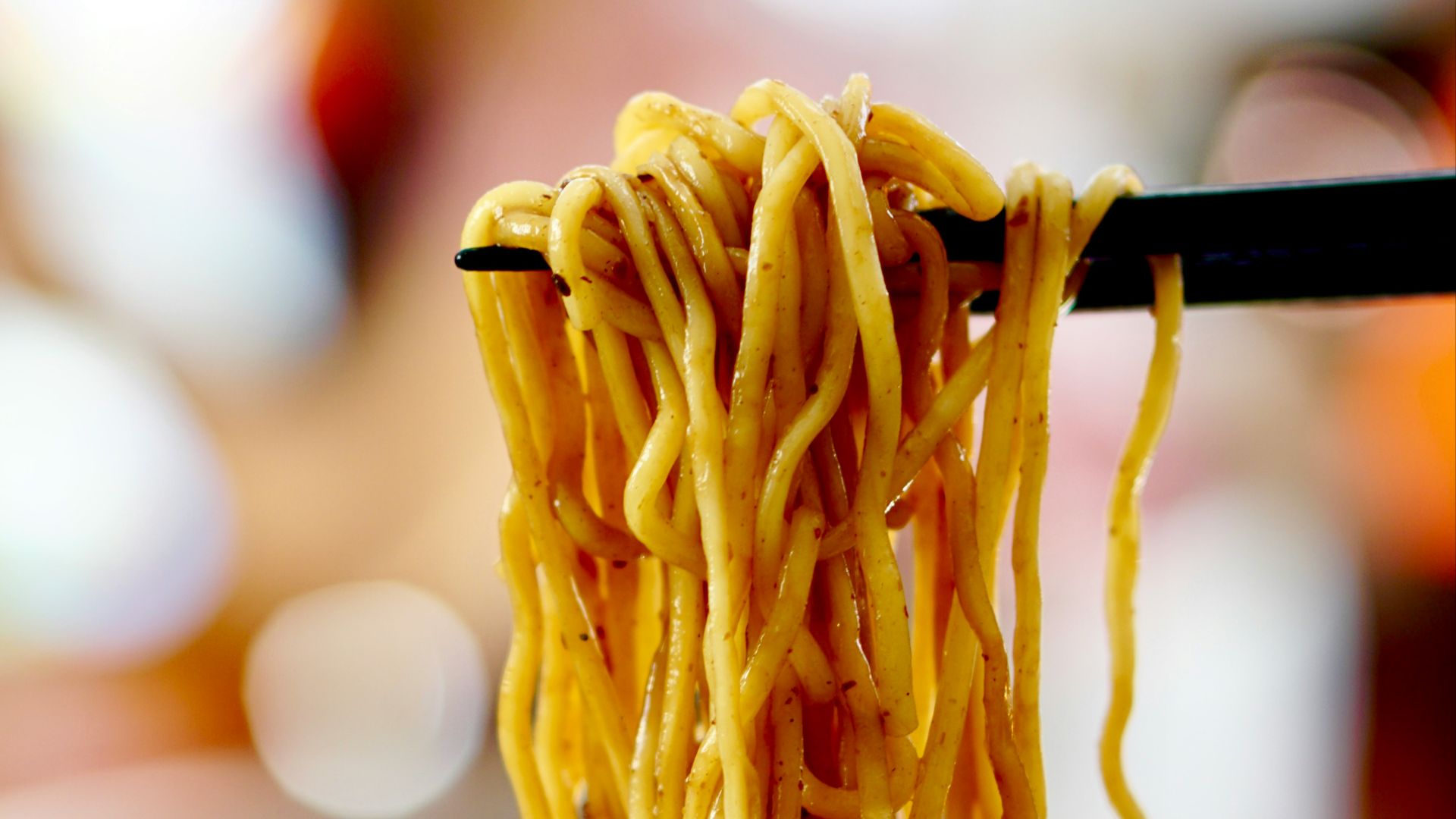 yellow pasta on blue and white ceramic bowl