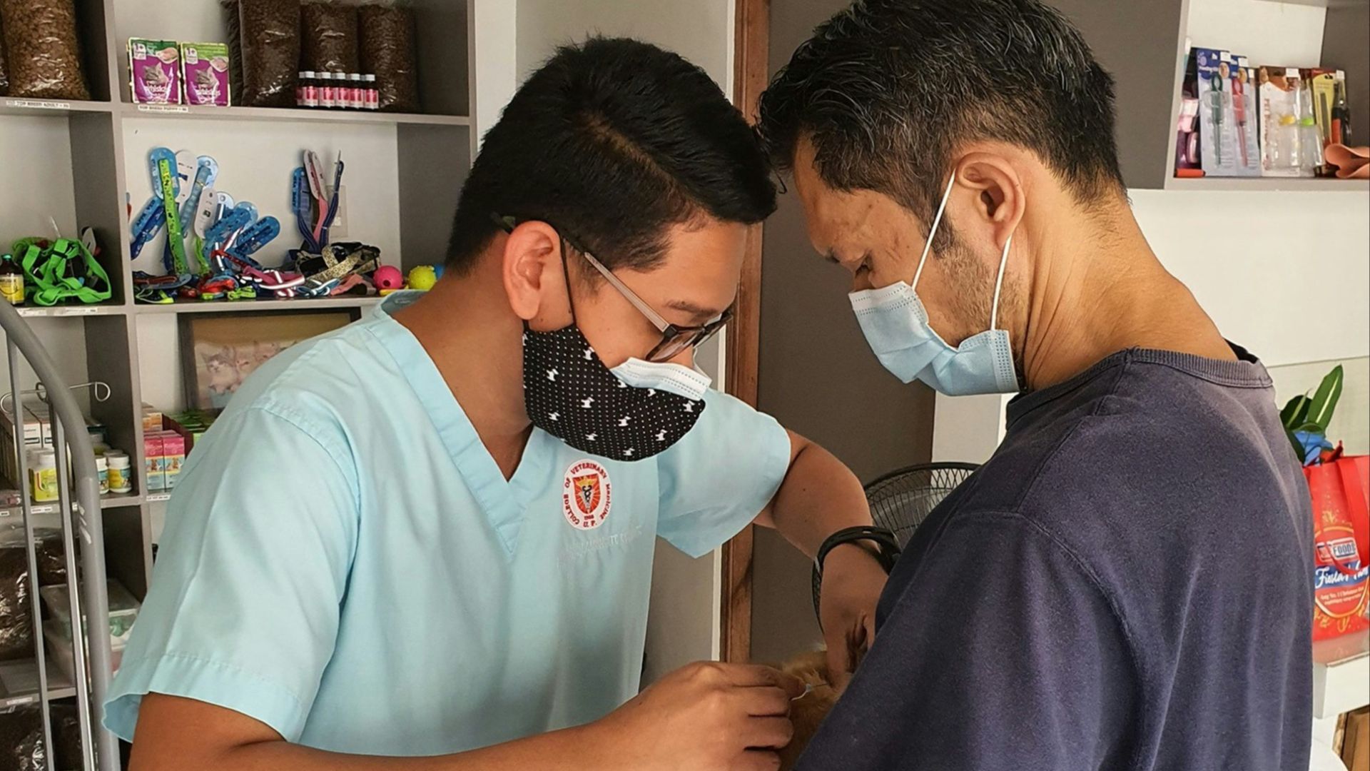 a man in a blue shirt and a man in a blue shirt and a dog