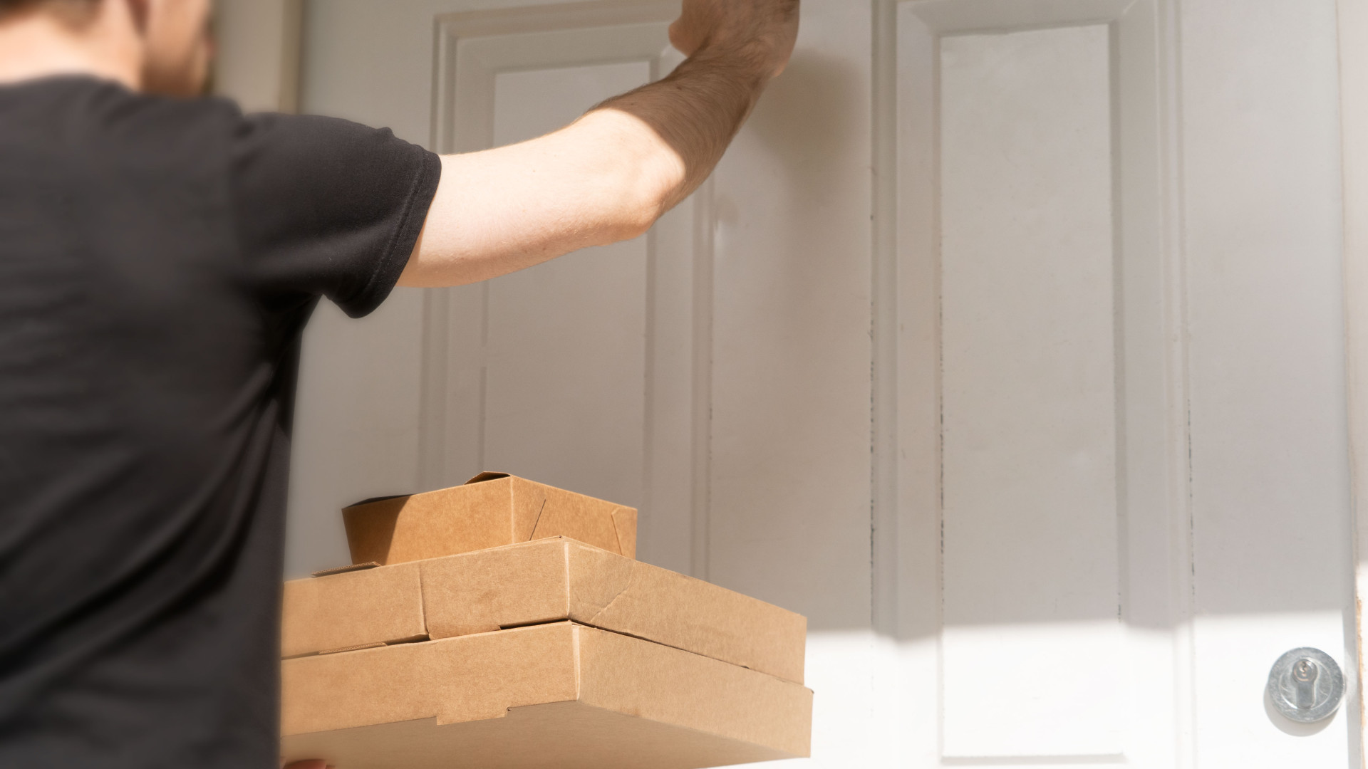 File:A Delivery Driver Knocking on a Door to Deliver Packages.jpg