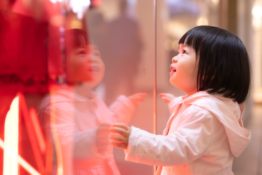 girl touching glass panel
