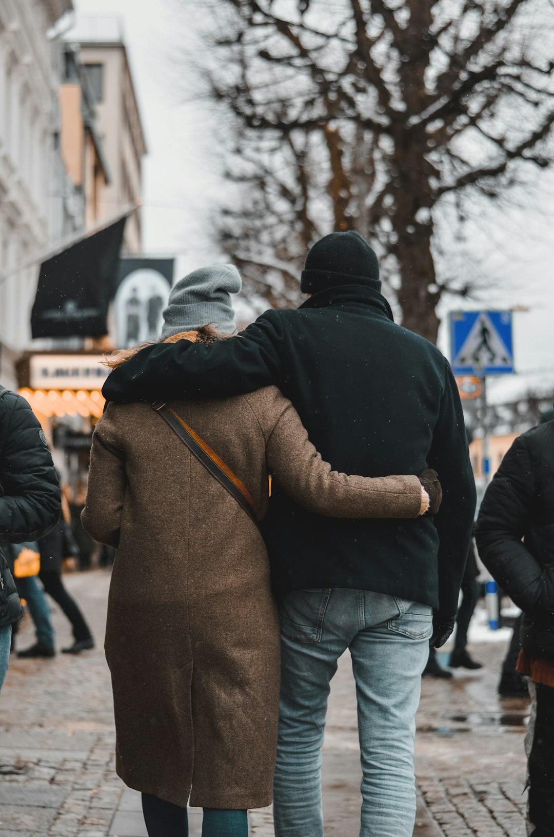 a couple of people walking down a street