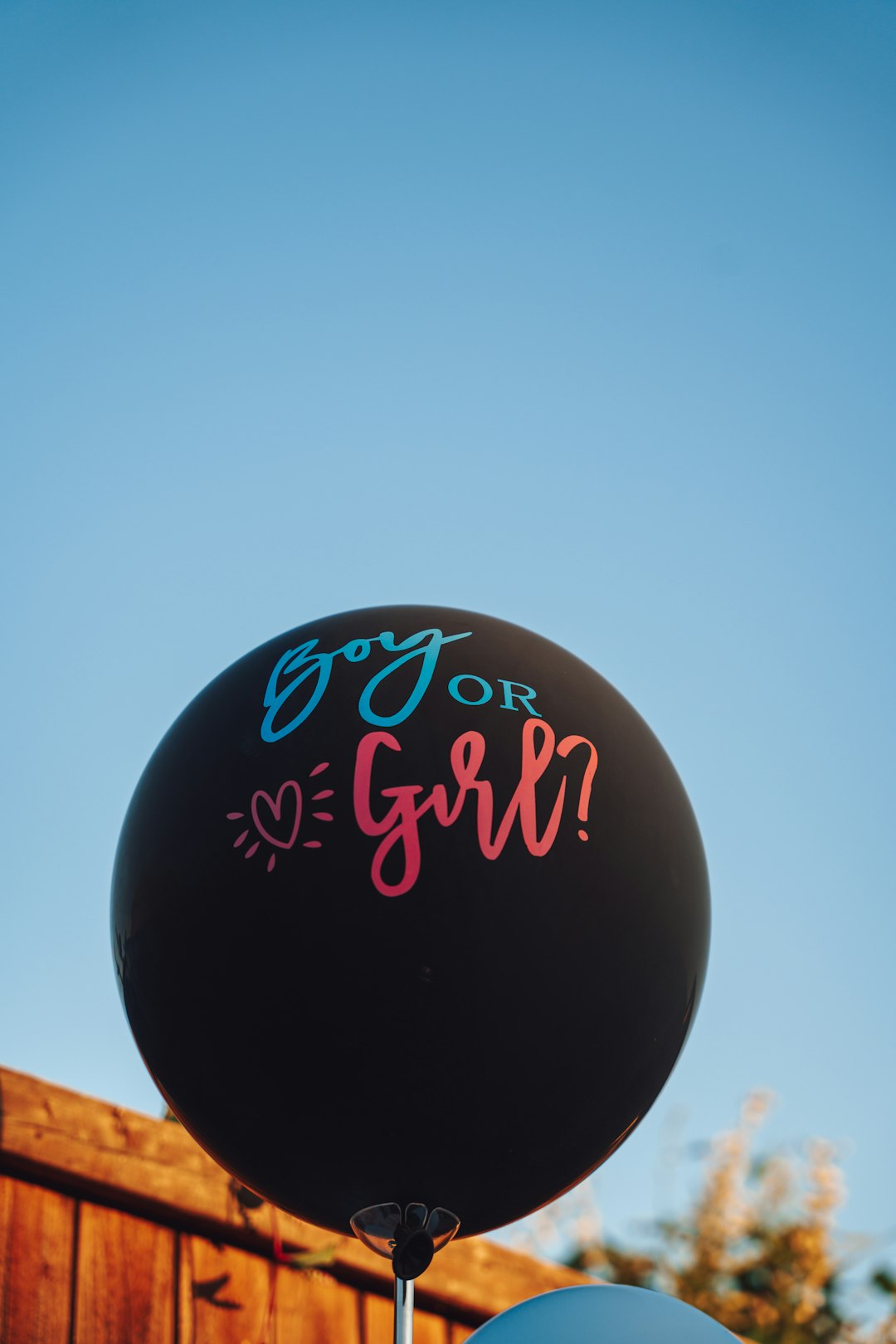 A black balloon with pink writing on it
