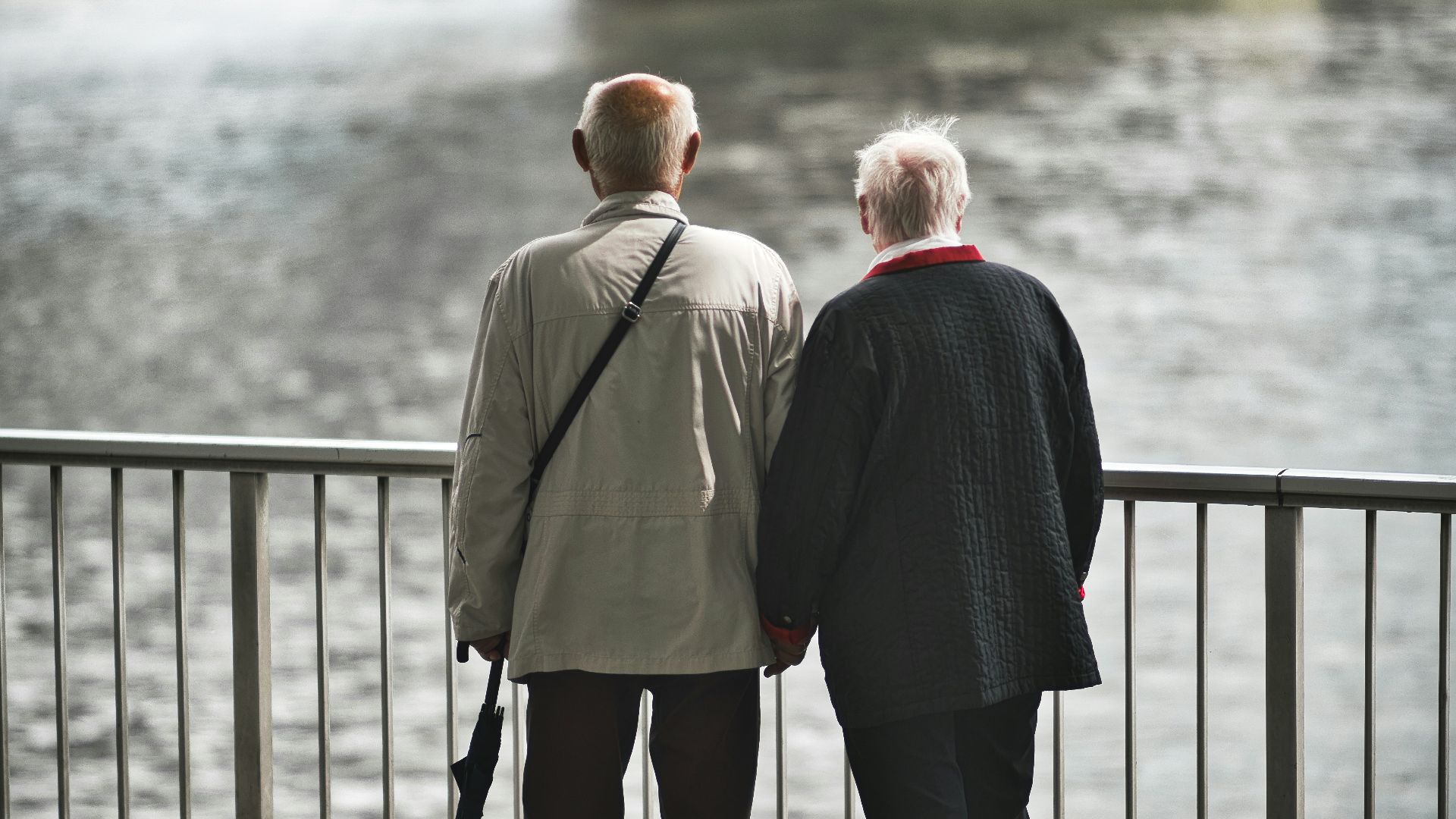 man in gray suit standing near body of water during daytime