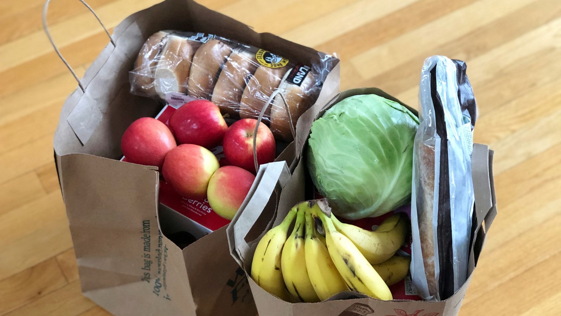 apples and bananas in brown cardboard box