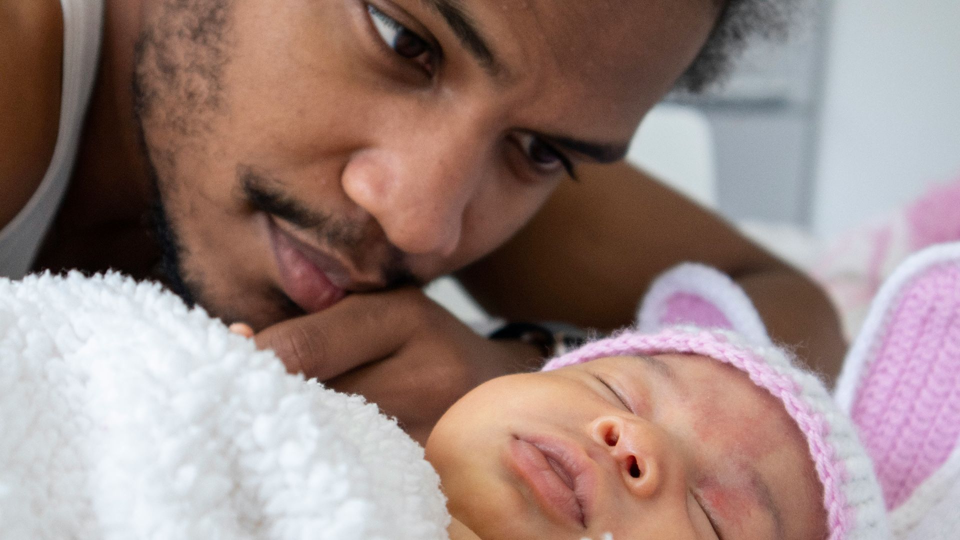 man lying on white textile