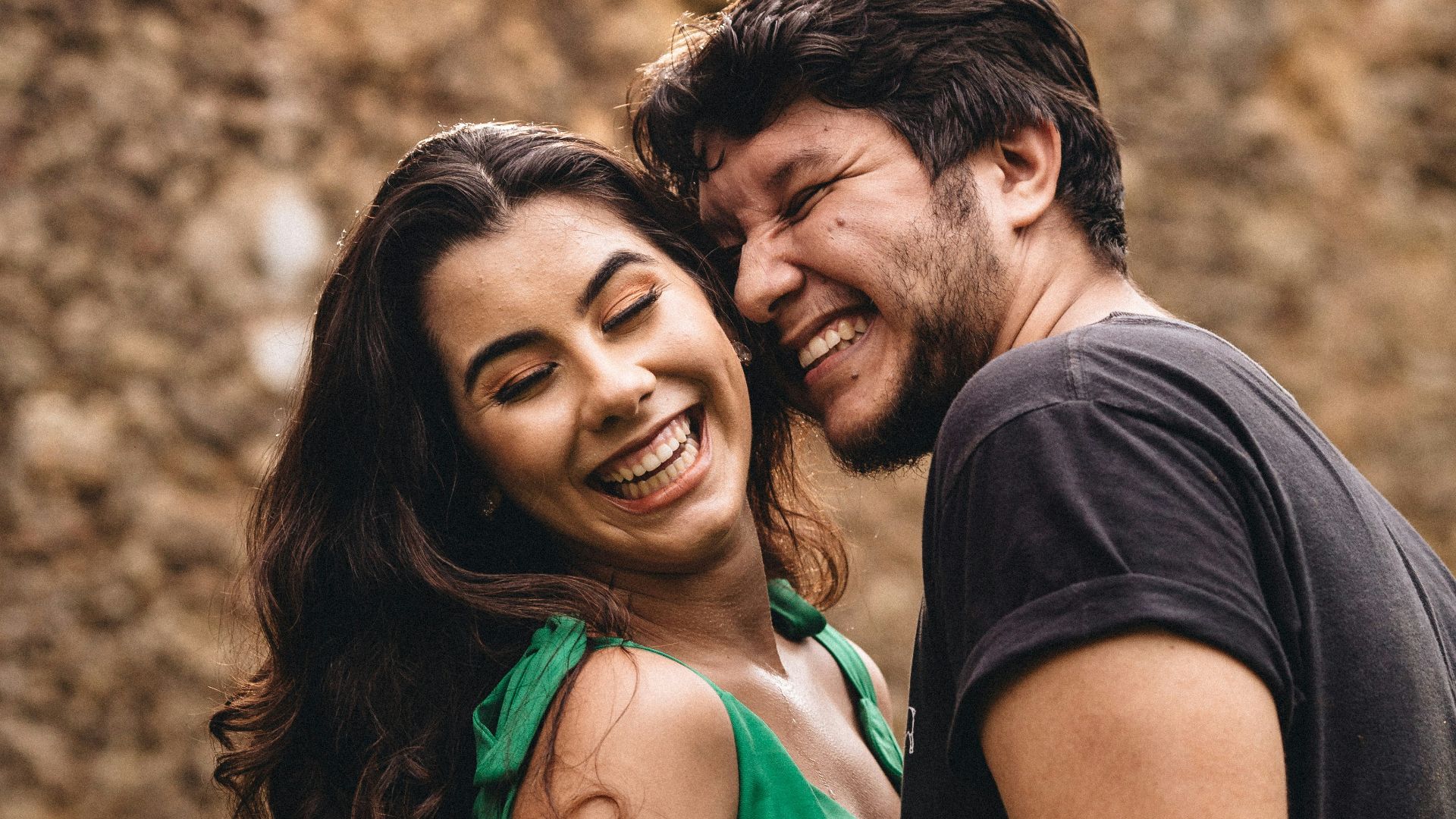 man in black crew neck shirt beside woman in green tank top