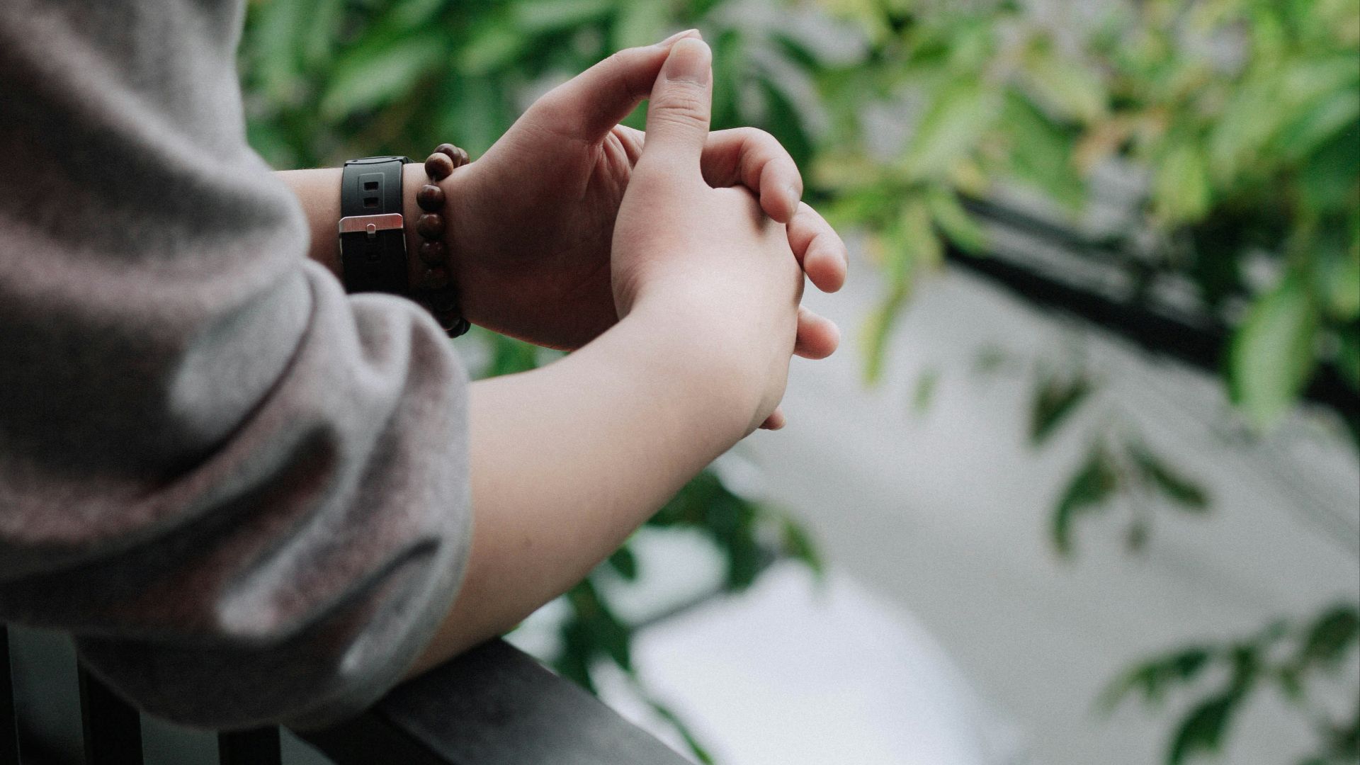 person in gray long sleeve shirt holding babys hand