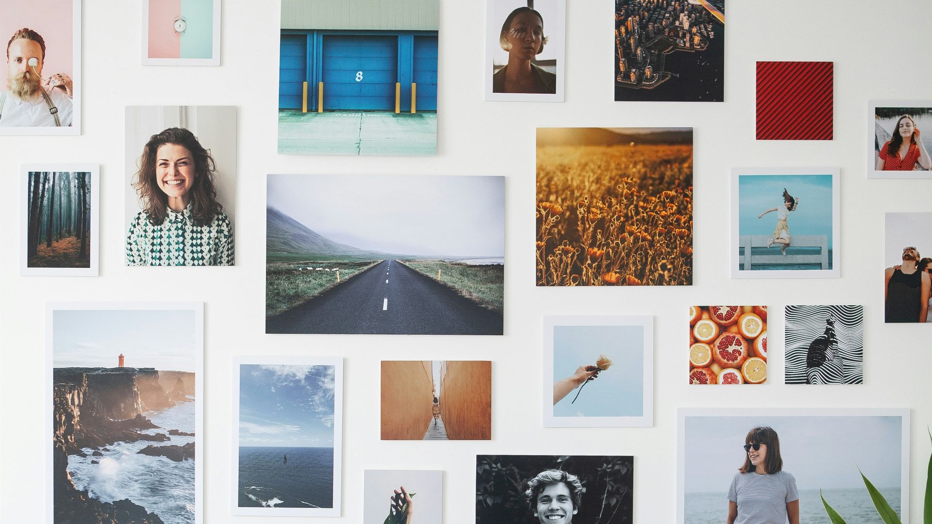 a bed with a bunch of pictures on the wall