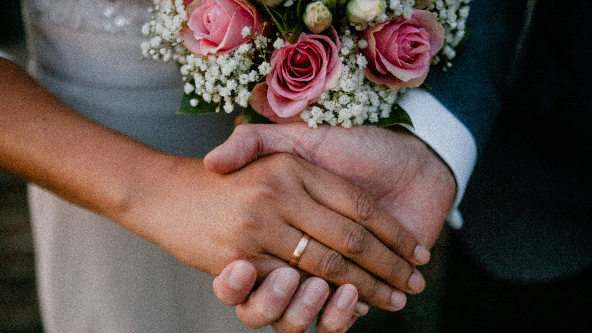 man and woman standing while holding hands