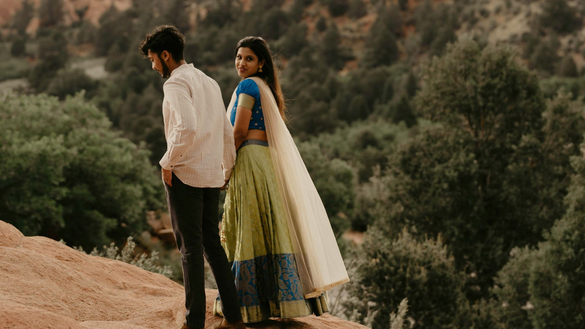 a man standing on a rocky hill