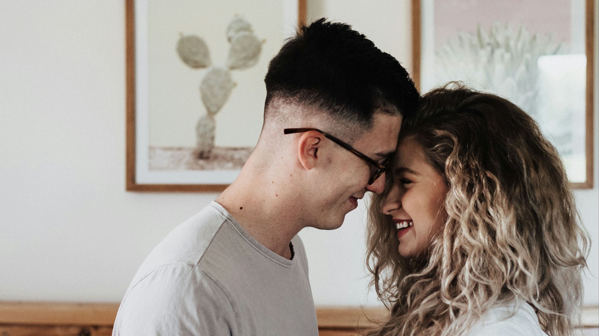 man in gray polo shirt sitting beside woman in white shirt