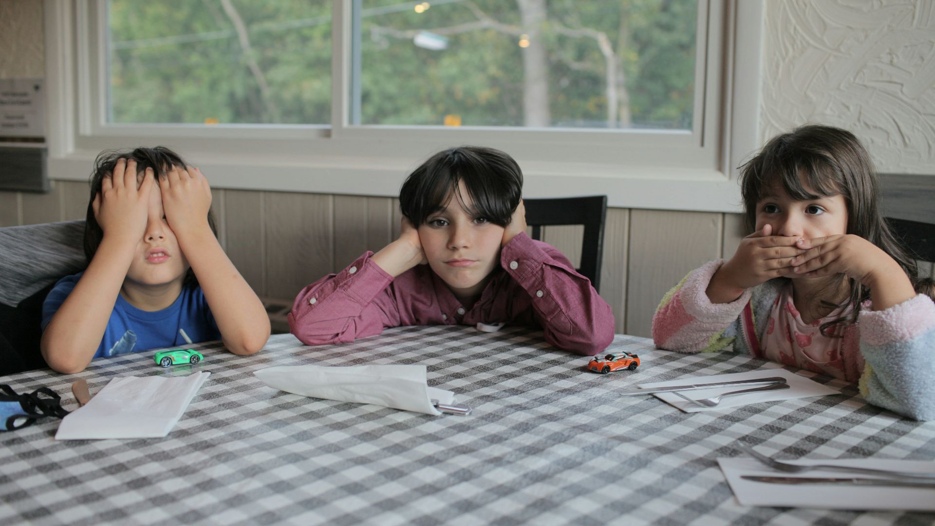 2 women sitting on chair in front of table