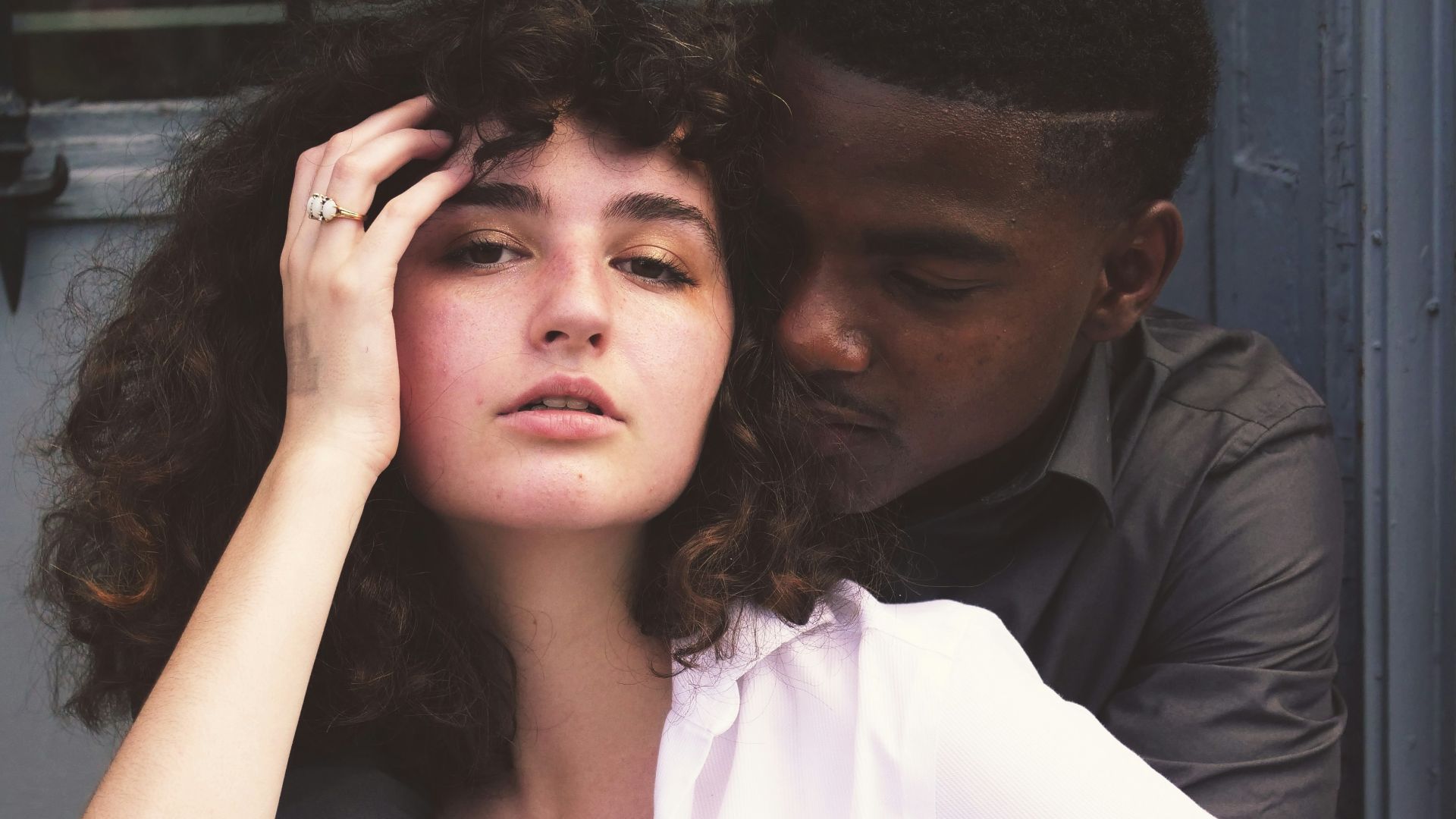 man hugging woman while taking photo of each other