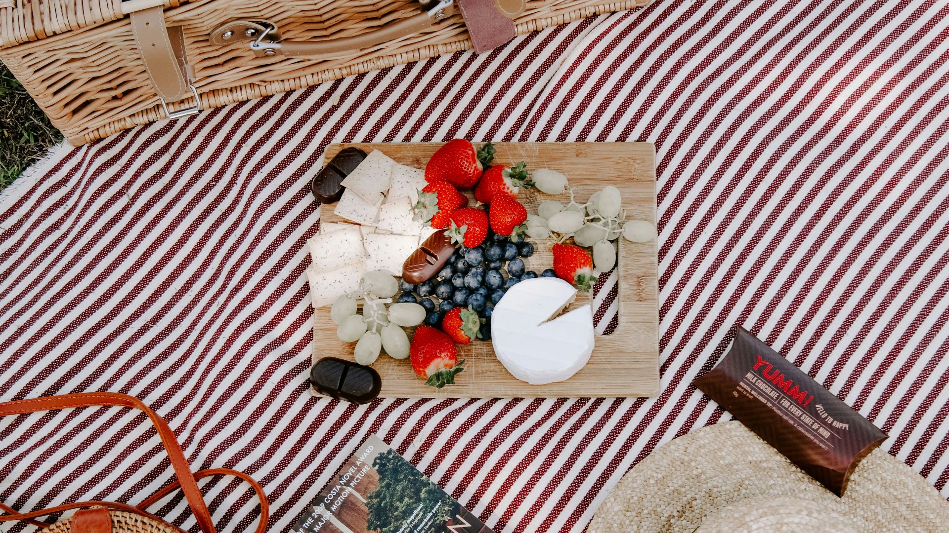 Brooklyn book near brown hat on textile