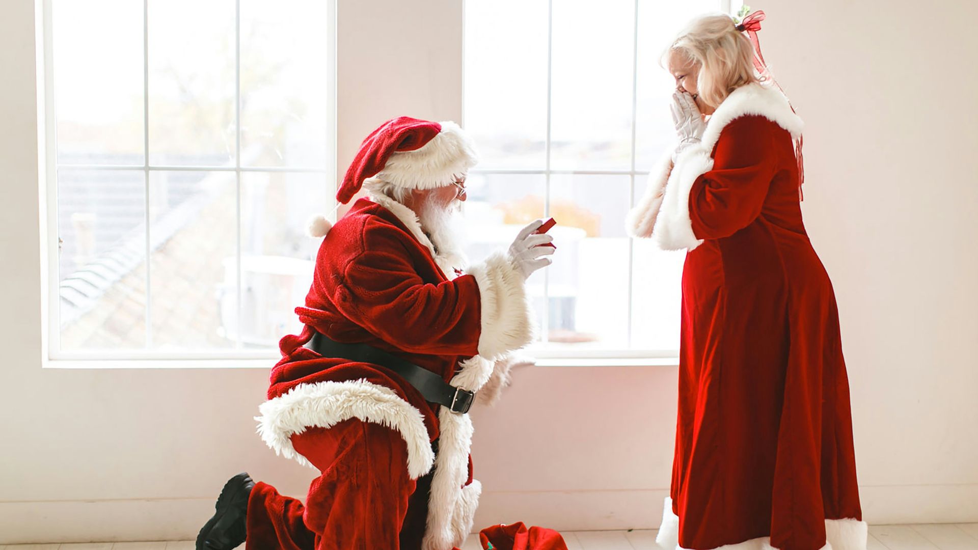 a man dressed as santa claus and a woman dressed as santa claus