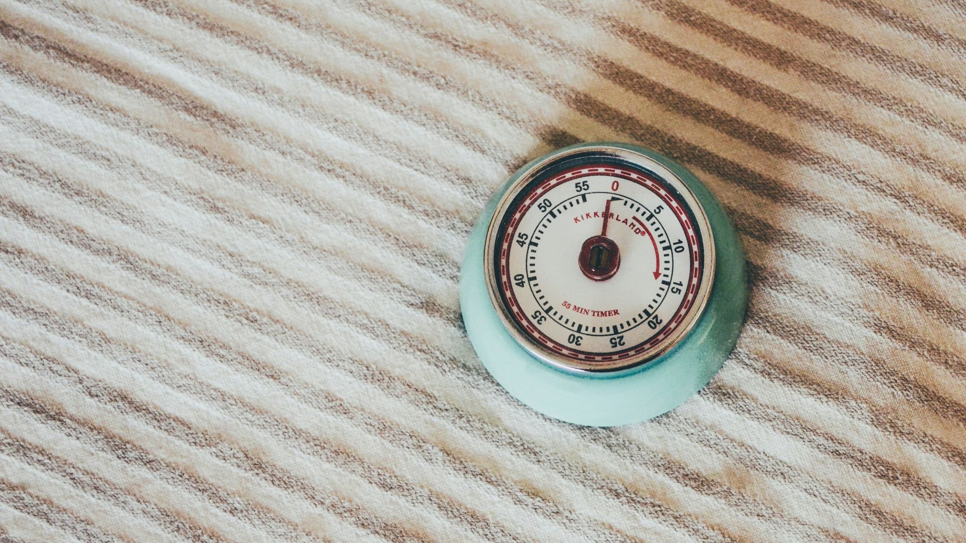 round teal gauge on white textile