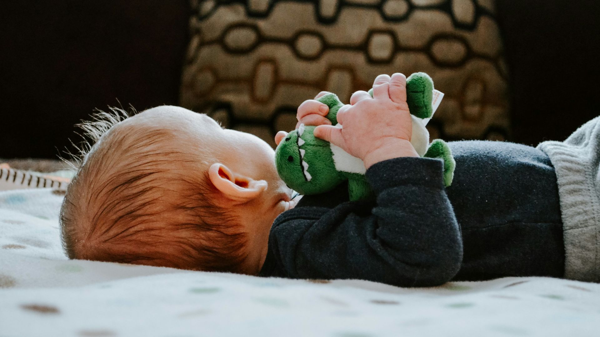 baby lying on white bed