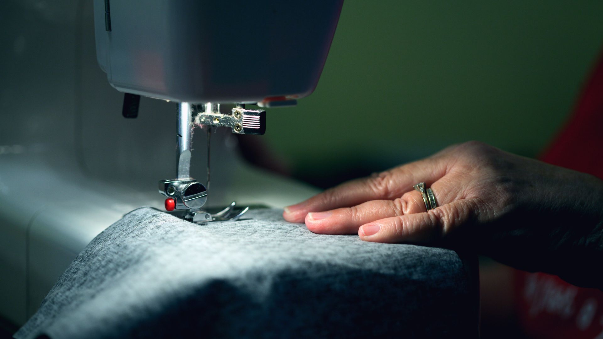 person in gray shirt sewing