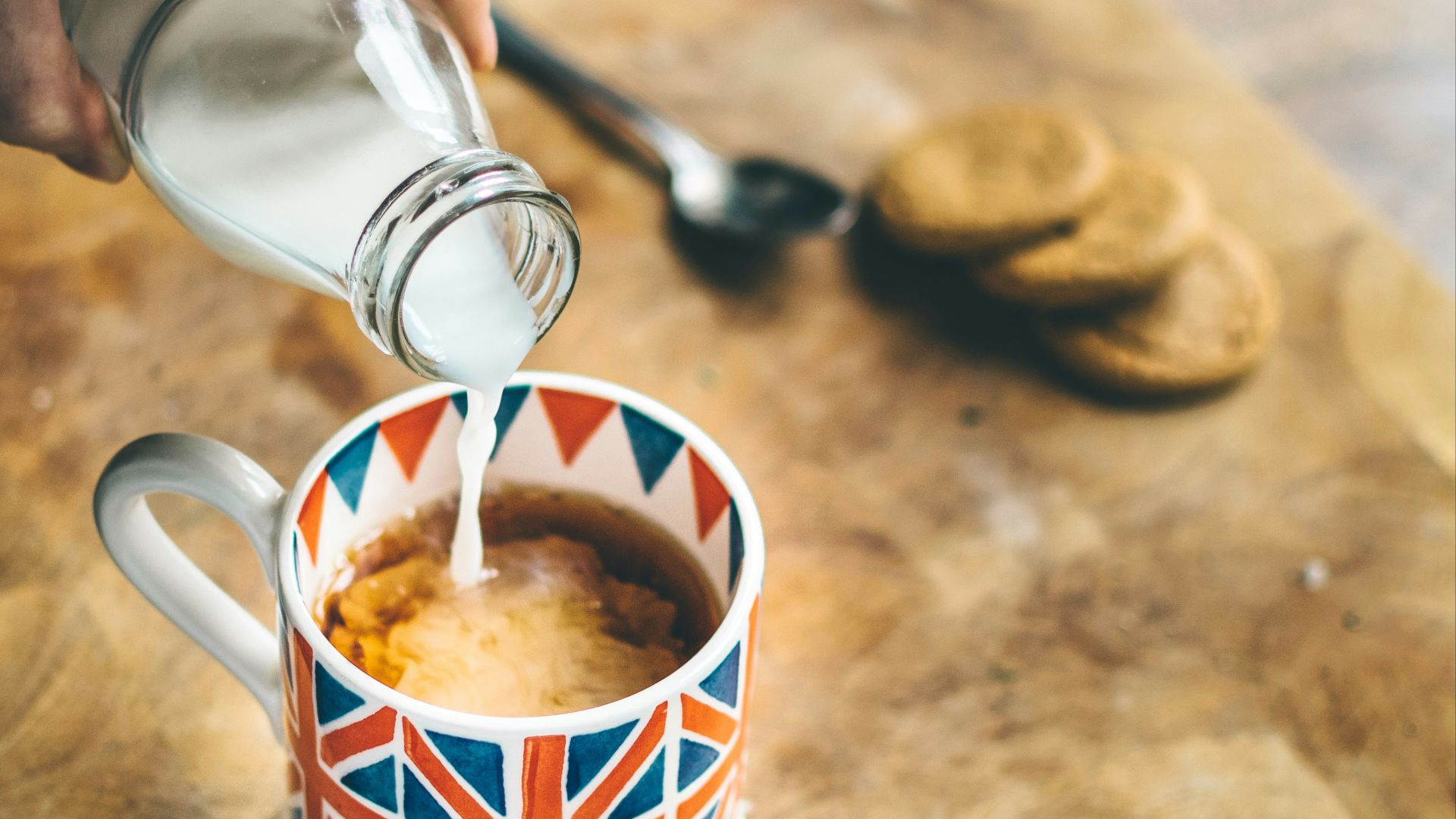 blue, red, and white mug filled with coffee