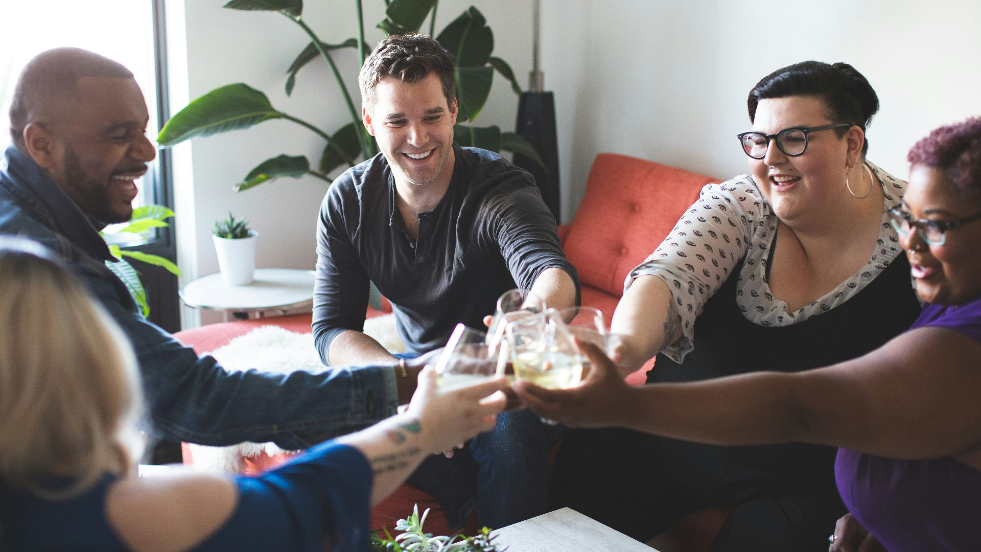 people sitting and toasting indoors