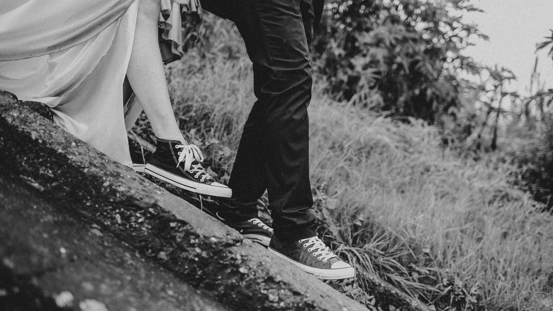 grayscale photography of man and woman standing on ground