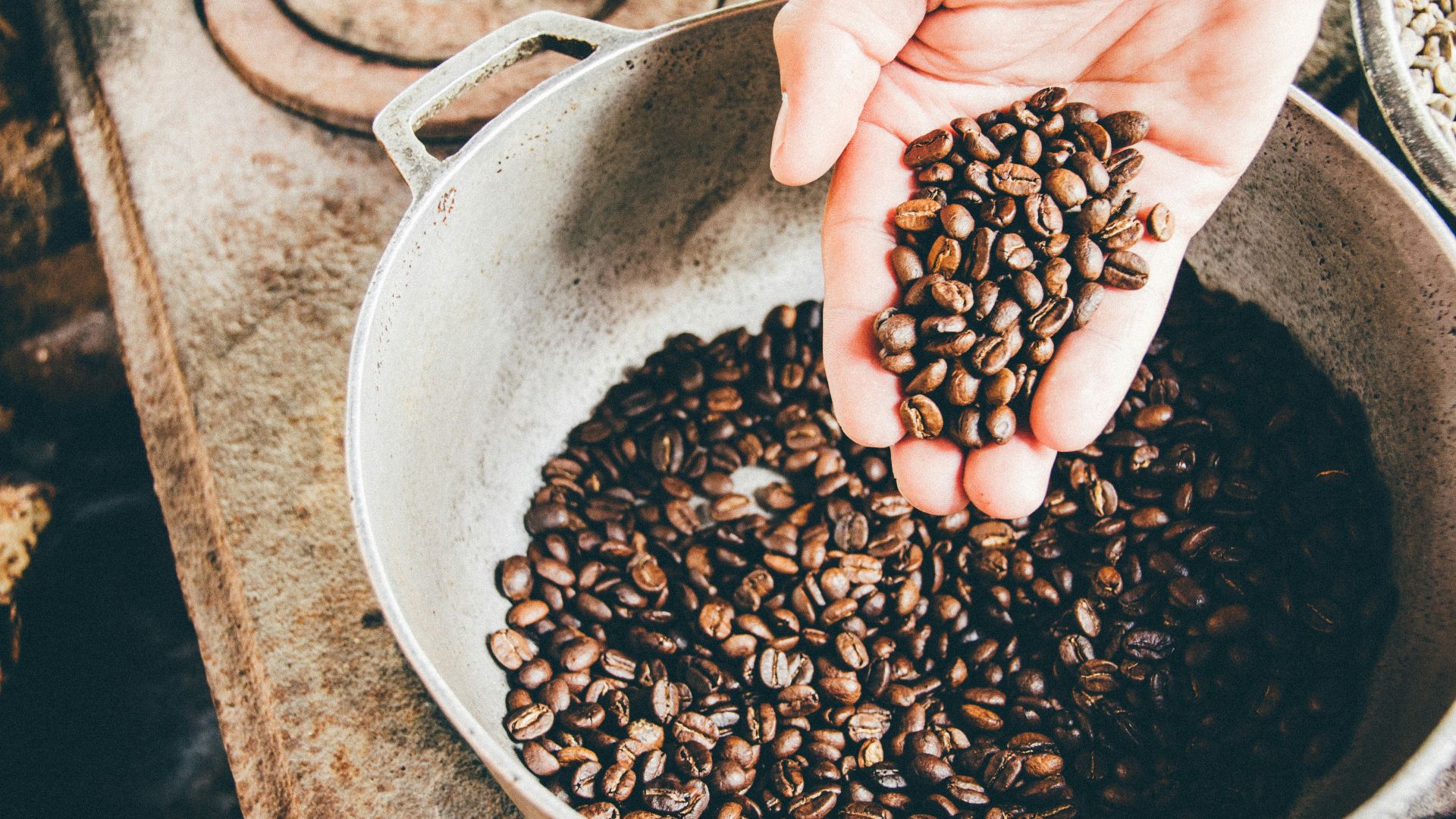coffee beans on gray steel wok