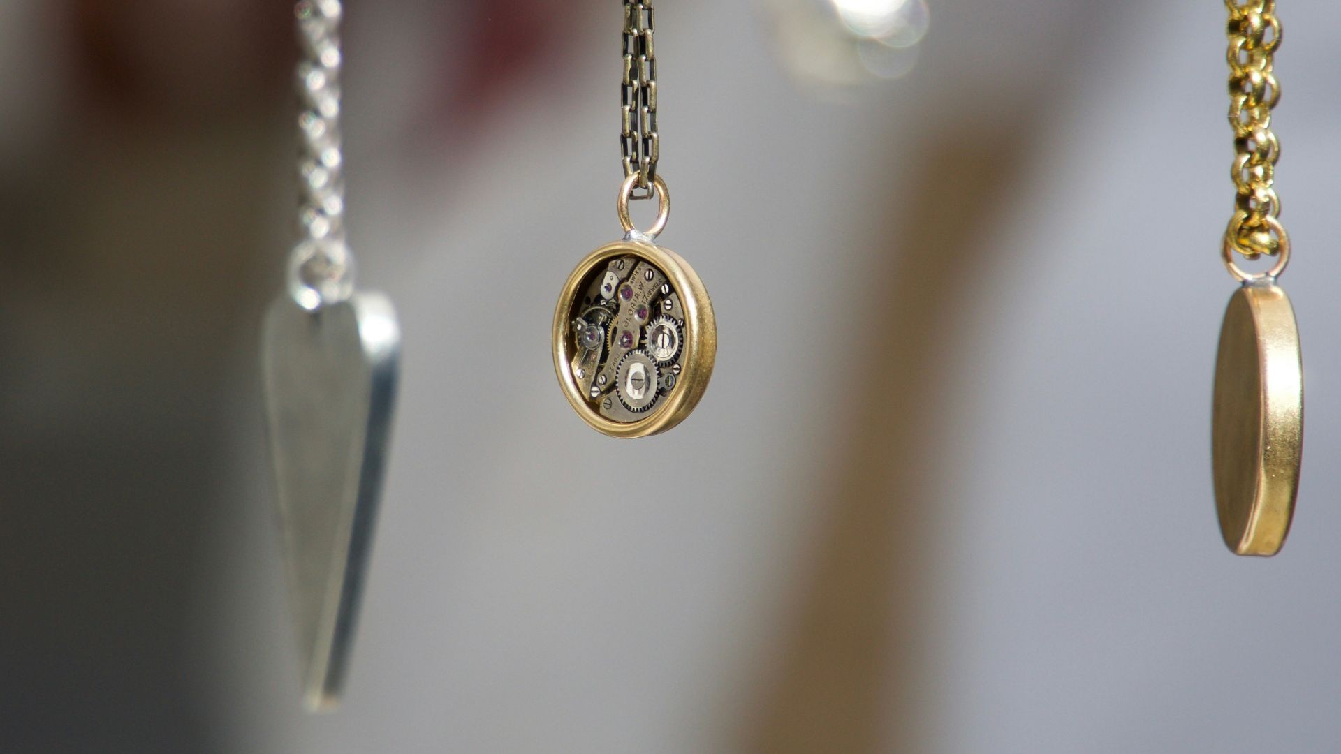 gold-and-silver-colored pendant necklace