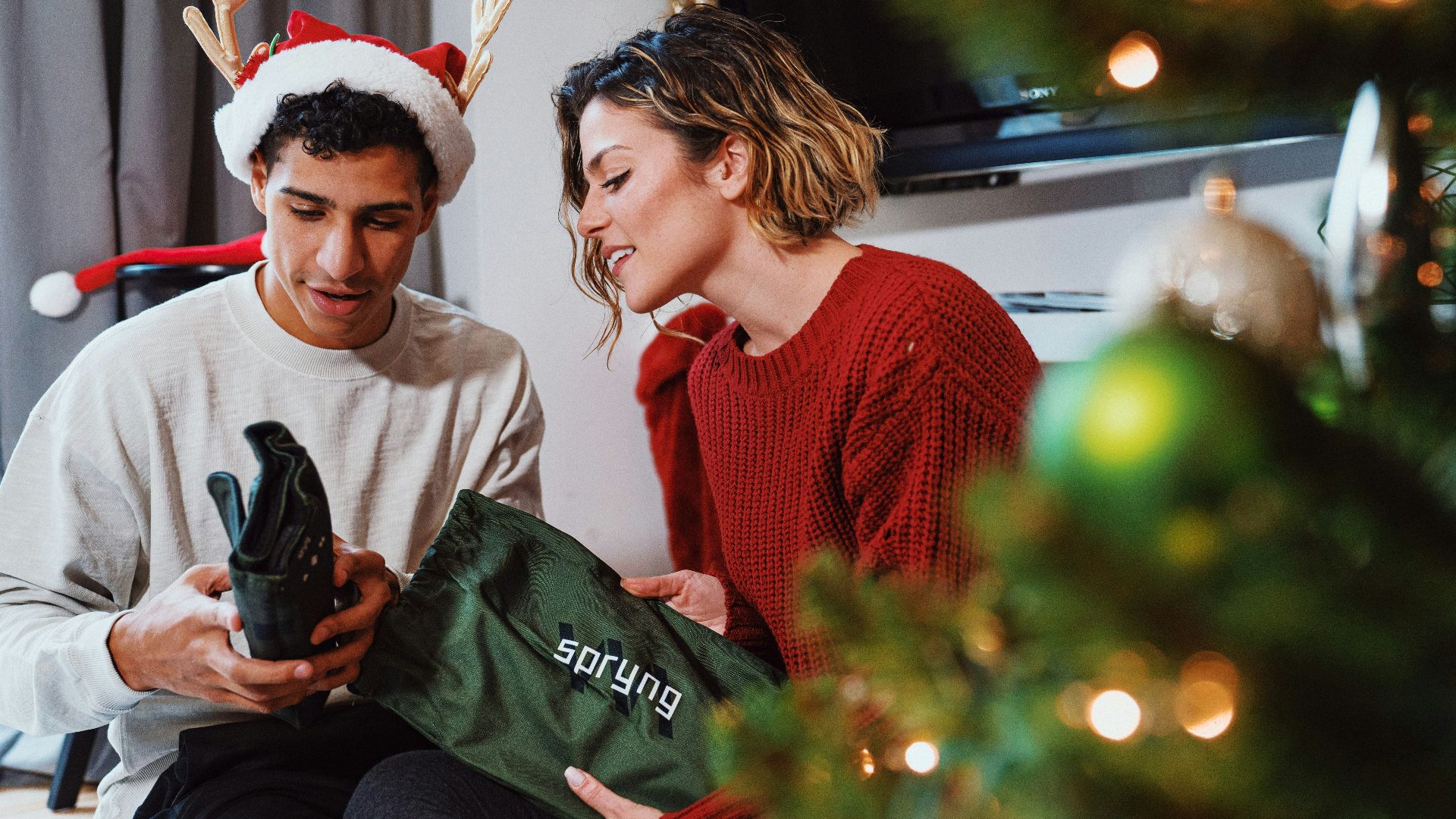 a man and woman looking at a cell phone