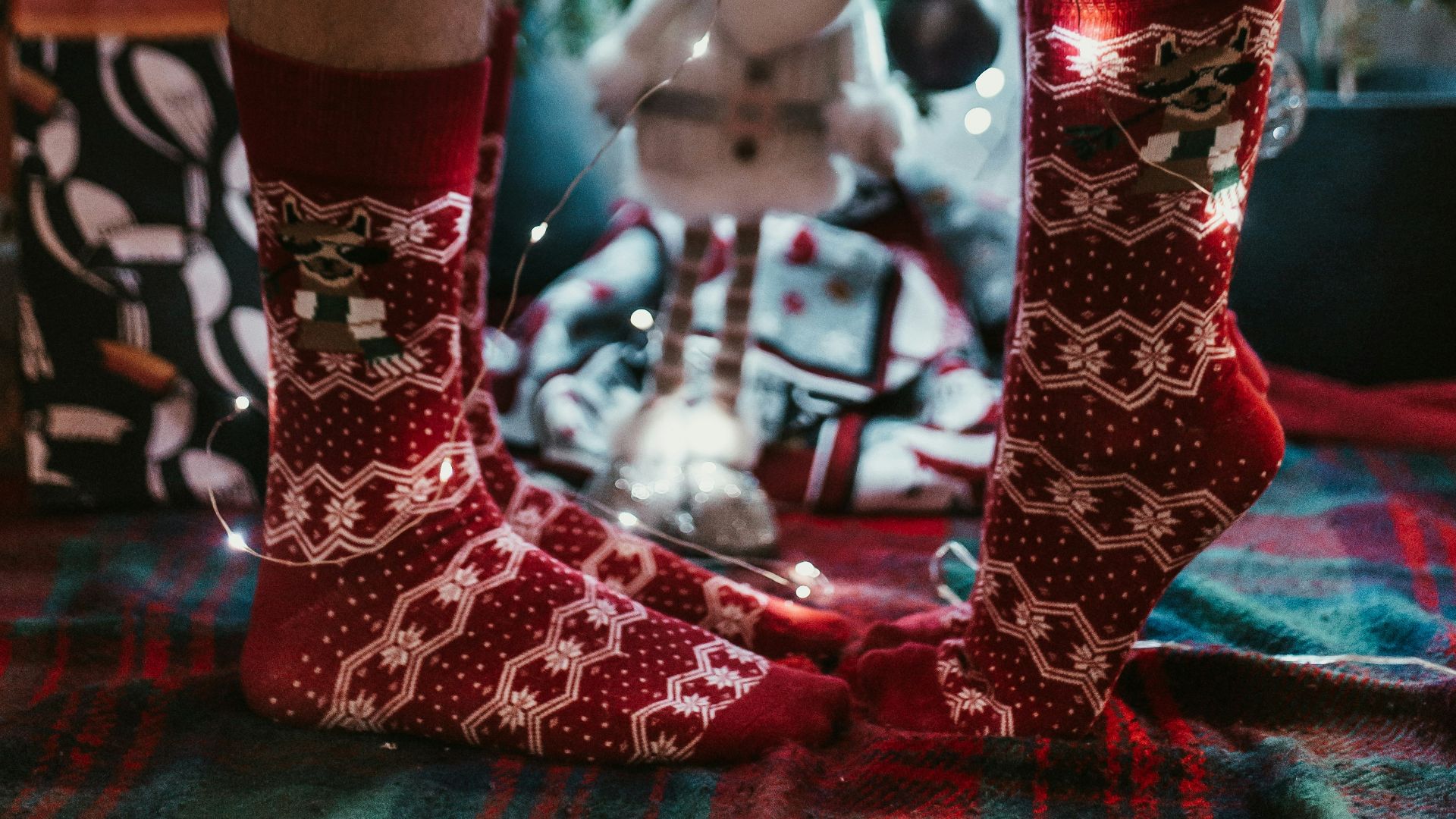 man and woman wearing red-and-white socks standing